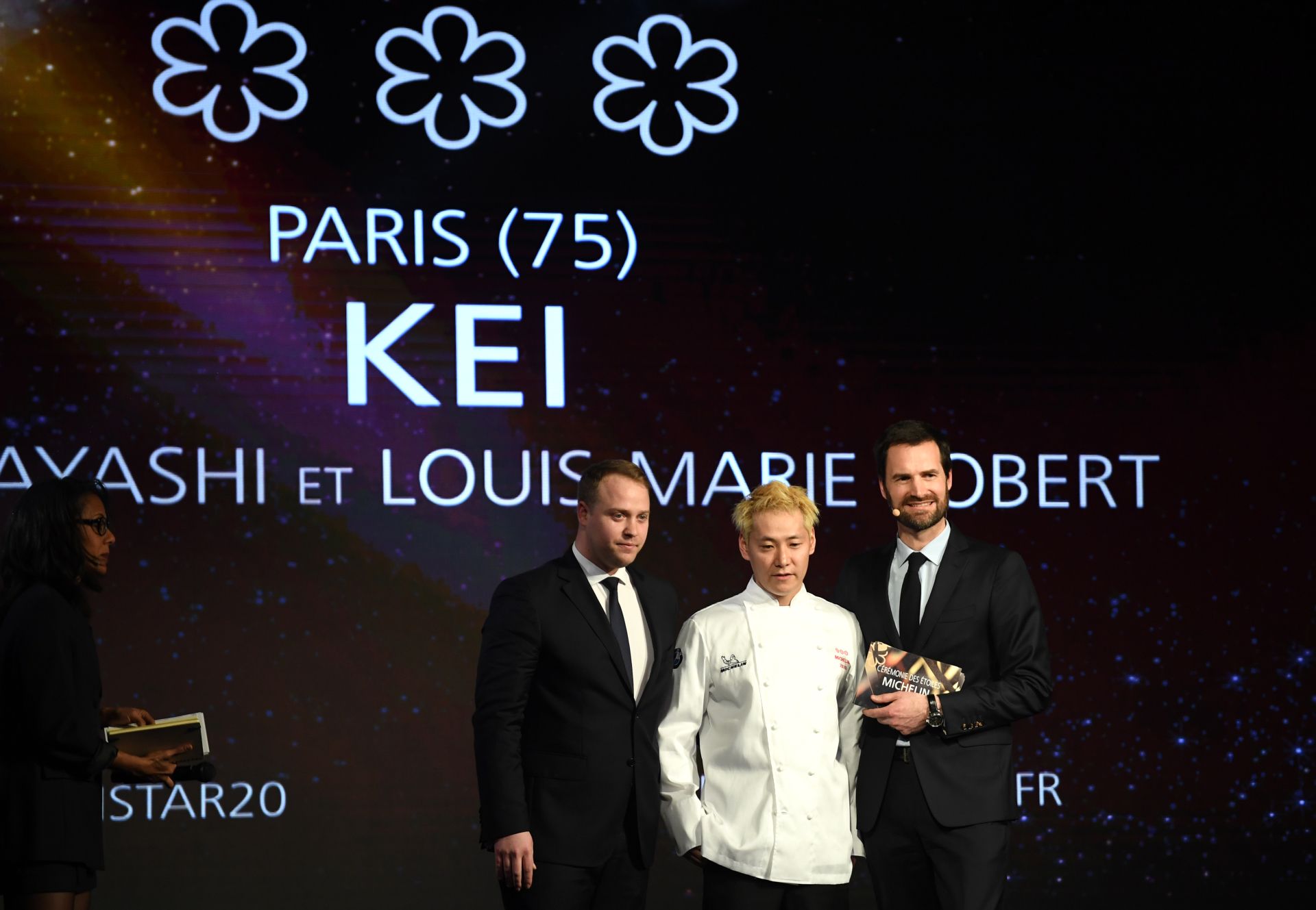 Michelin guide international director Gwendal Poullennec (R) stands on stage next to Japanese chef Kei Kobayashi (C) of restaurant Kei awarded with three star, during the Gala' of Michelin Guide 2020' list of top restaurants and chefs in Paris, on January 27, 2020. - According to Michelin, restaurants are selected on four criteria: the quality of the ingredients used, mastery of flavour and cooking techniques, the personality of the chef reflected in their cuisine, and the value for money and consistency be