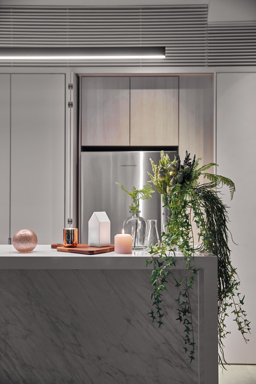 A marble island counter in the kitchen creates a space to gather