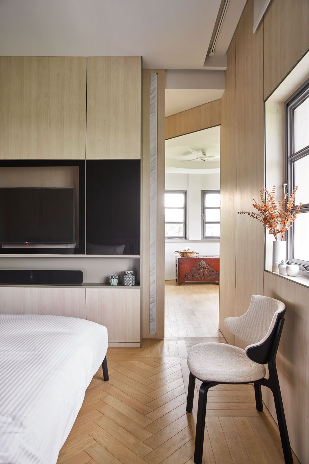 Family heirlooms such as an antique trunk add a personal touch to this minimalist bedroom