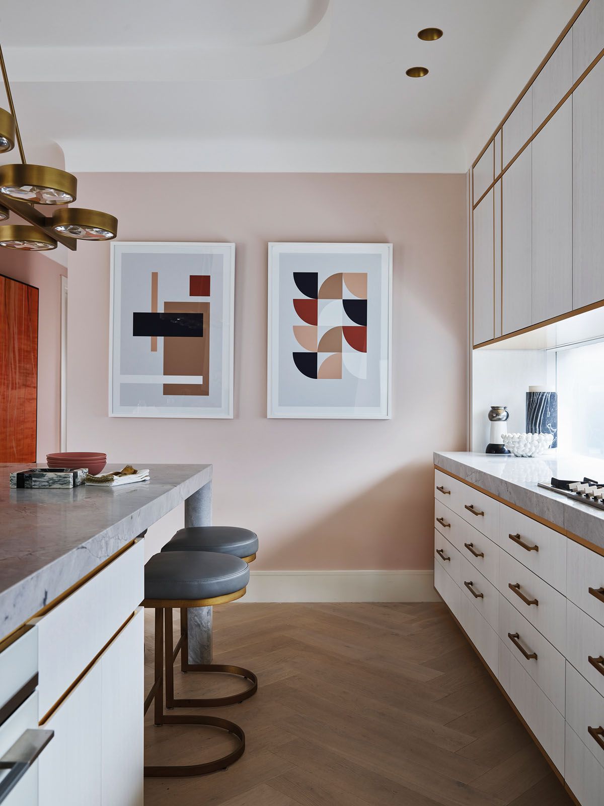 The white lacquered American oak shelving and cabinets enhance the light-filled nature of the kitchen