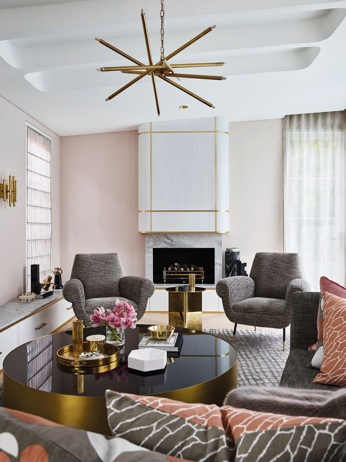 A custom-made Carrara marble fireplace holds court in the living room