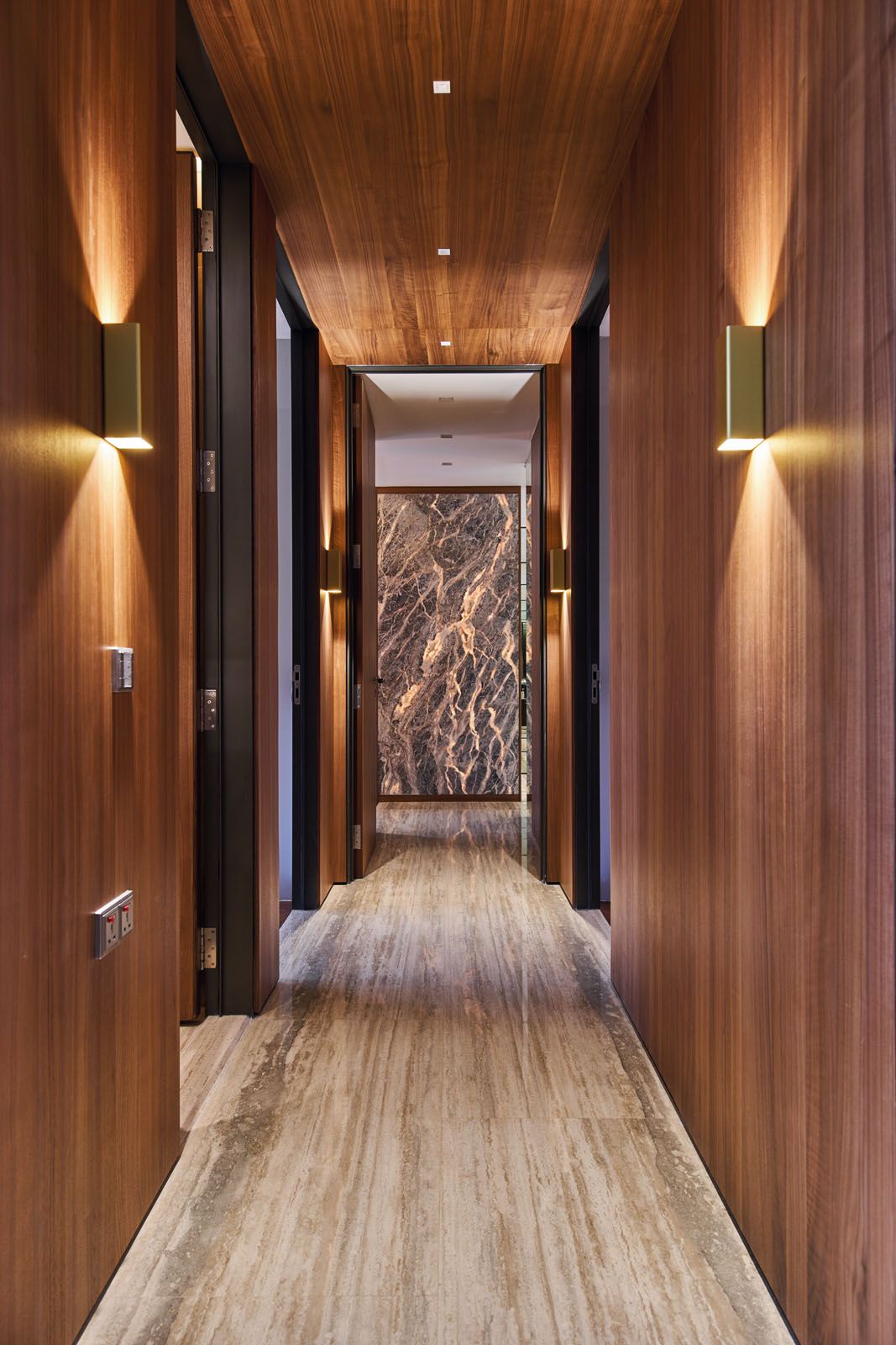 Visible from the hallway, the onyx feature wall in the master bedroom also functions as a privacy screen