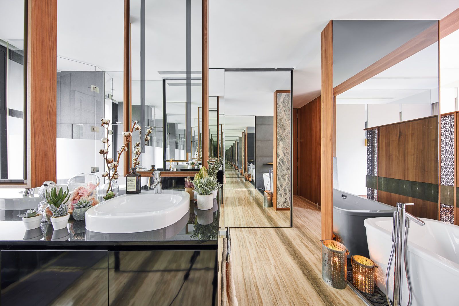 The clever use of glass in the master bathroom creates the illusion of an endless hallway;