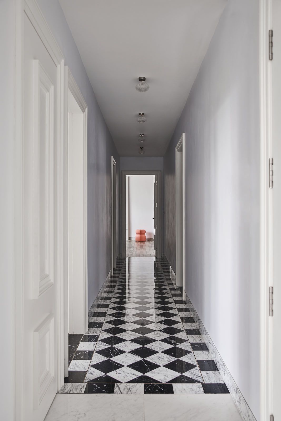 The corridor features a striking checkerboard pattern