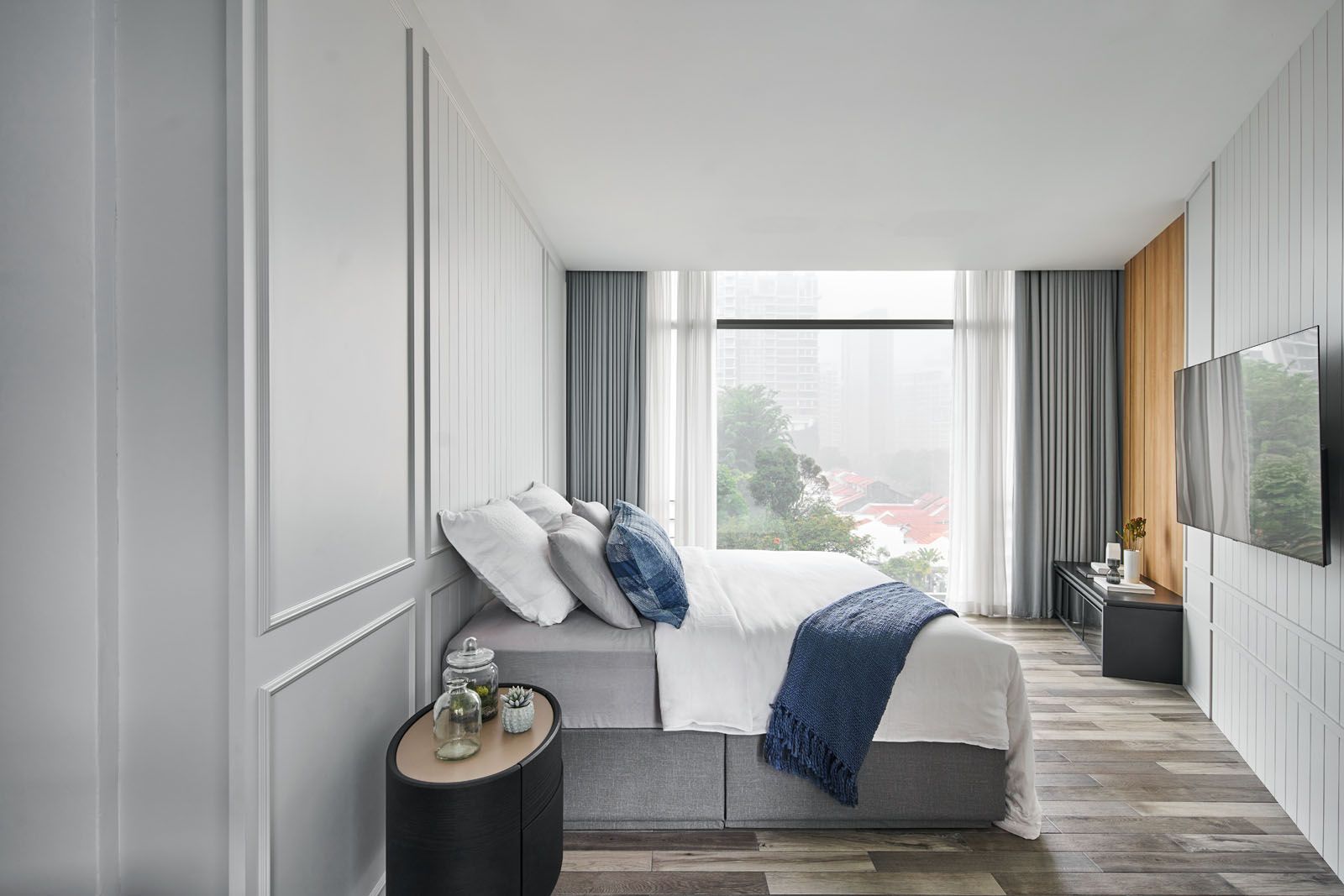 The master bedroom features a calming mix of light and dark wood, and minimal decoration