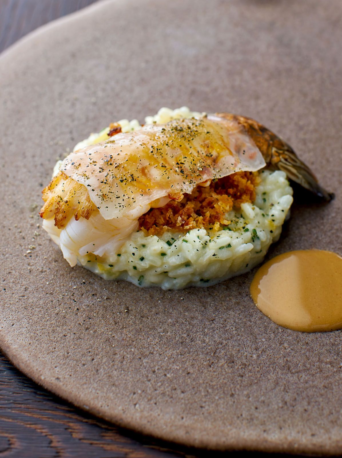 Wild caught crayfish topped with fermented prawn crumbs and lardo, paired with preserved lemon risotto and a bisque-like sauce made with crayfish shells
