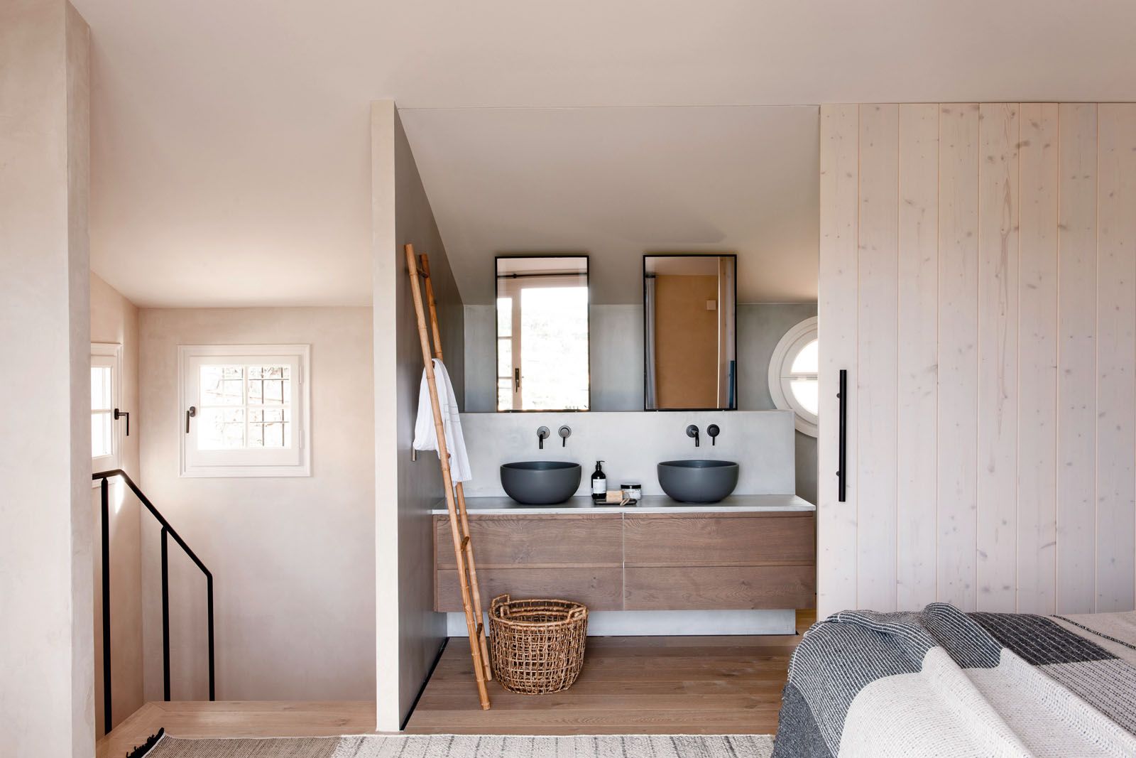 The bathrooms feature washbasins from Cielo Ceramica, taps from Bruma and mirrors with black iron frames