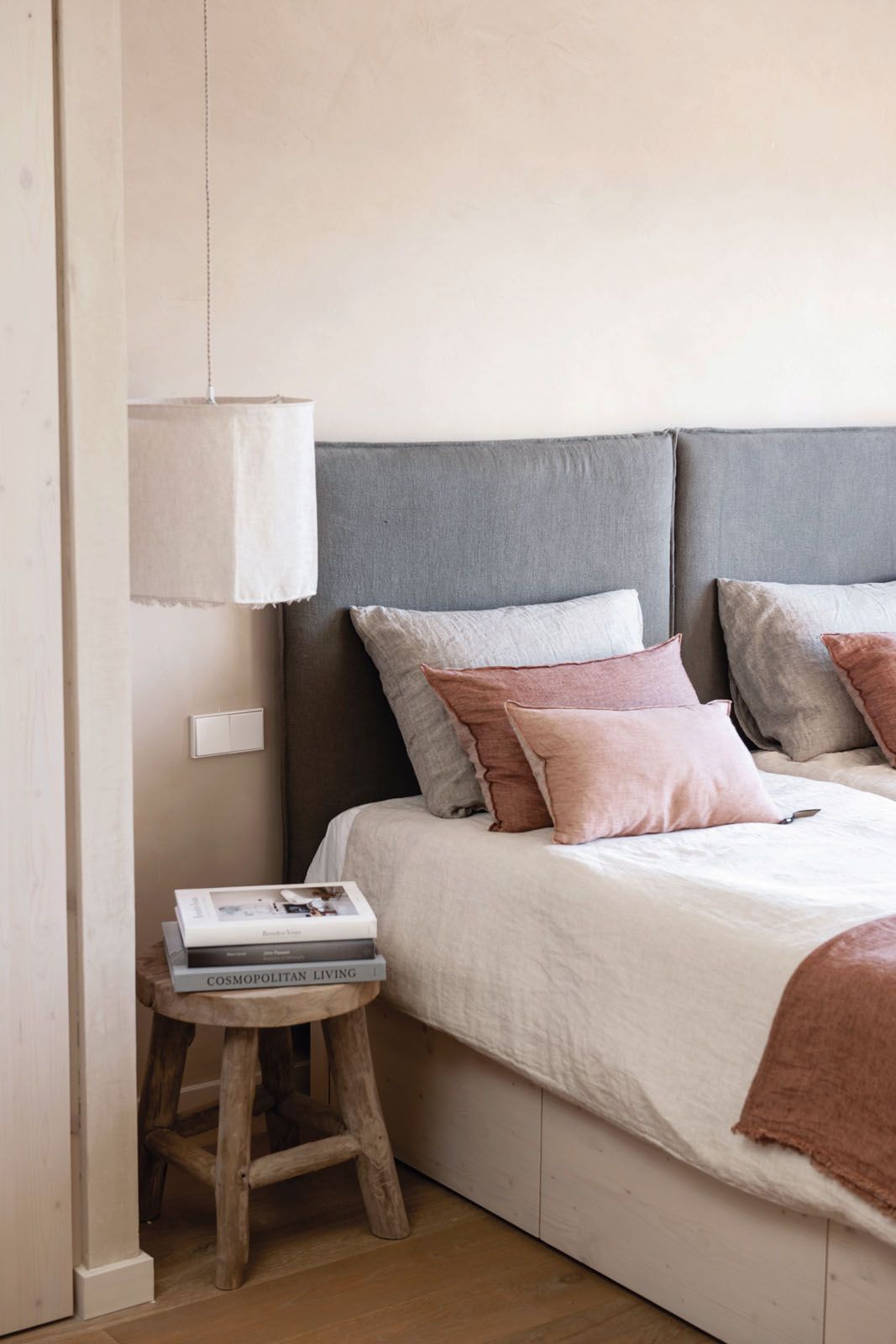 This bedroom features bed linens and cushions by Maison de Vacances