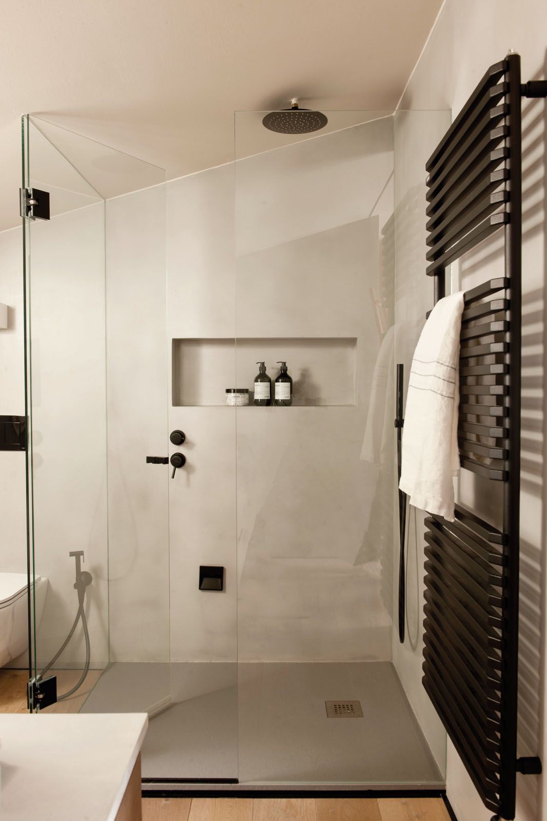 The black towel rails in the shower area are from Bruma