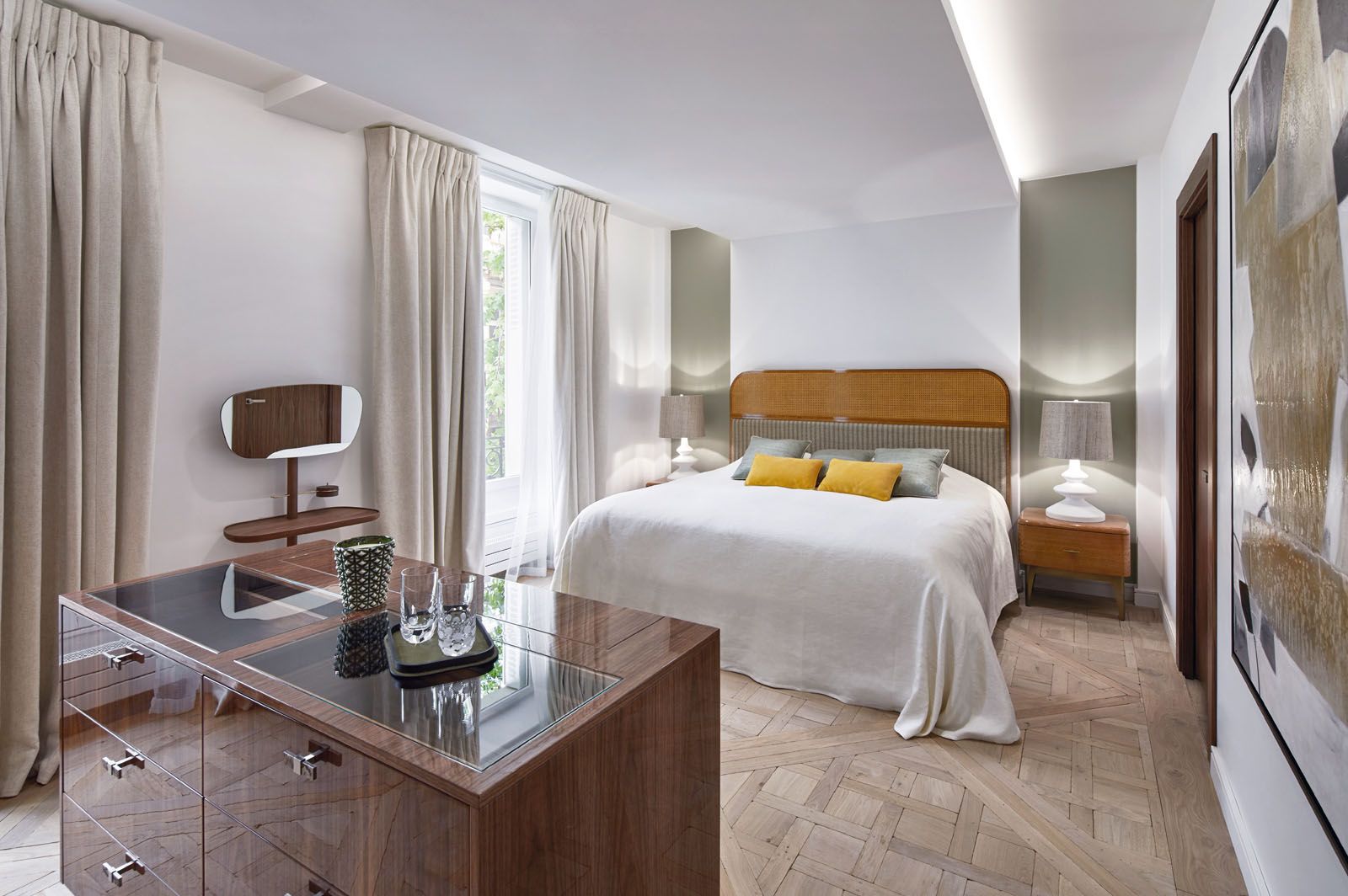 The master suite features a custom-made headboard, Ana Roque bedside tables, Nicholas Haslam silk lampshades and Zimmer + Rohde silk accent cushions