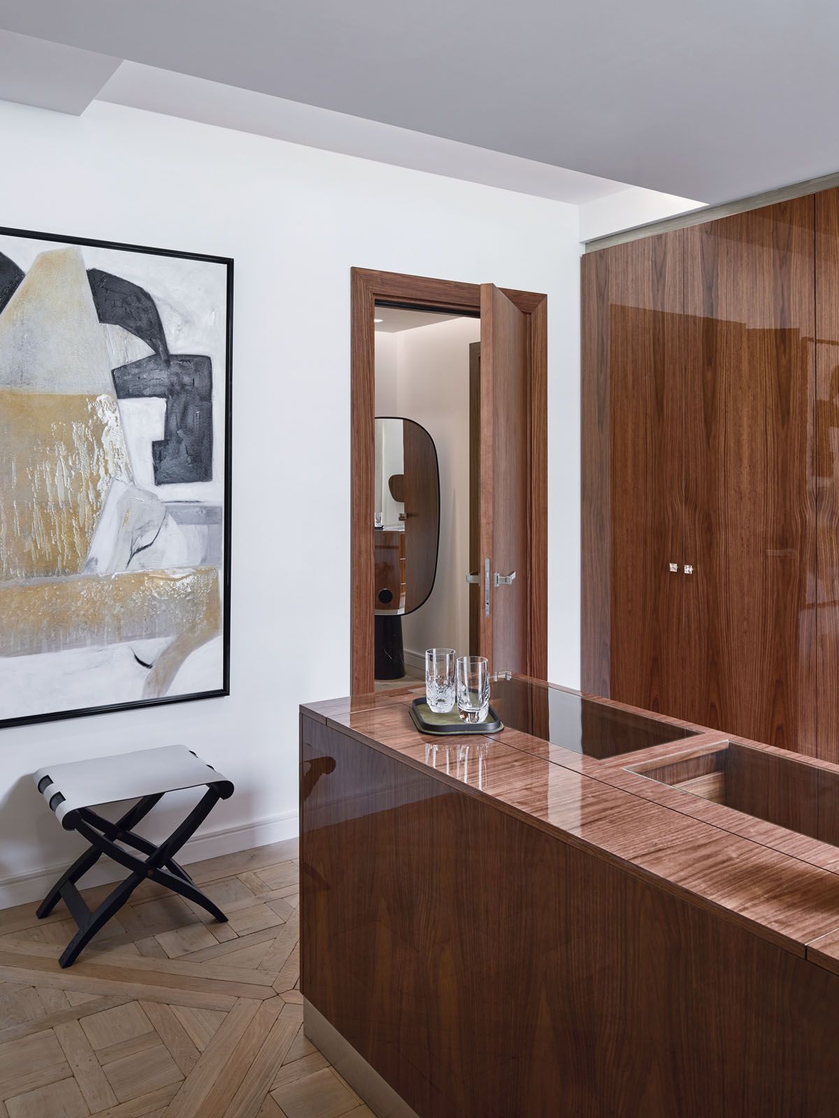 The wardrobe area in the master suite features cabinetry in a high-gloss varnish