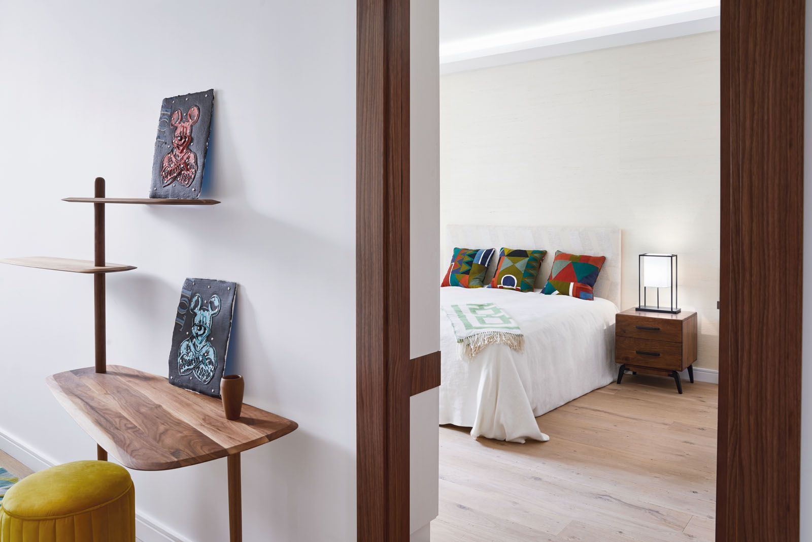 The guest room features wallpaper and cushions from Pierre Frey, a headboard upholstered in Nobilis fabric as well as a bedside table from Ana Roque and a Frezoli lamp