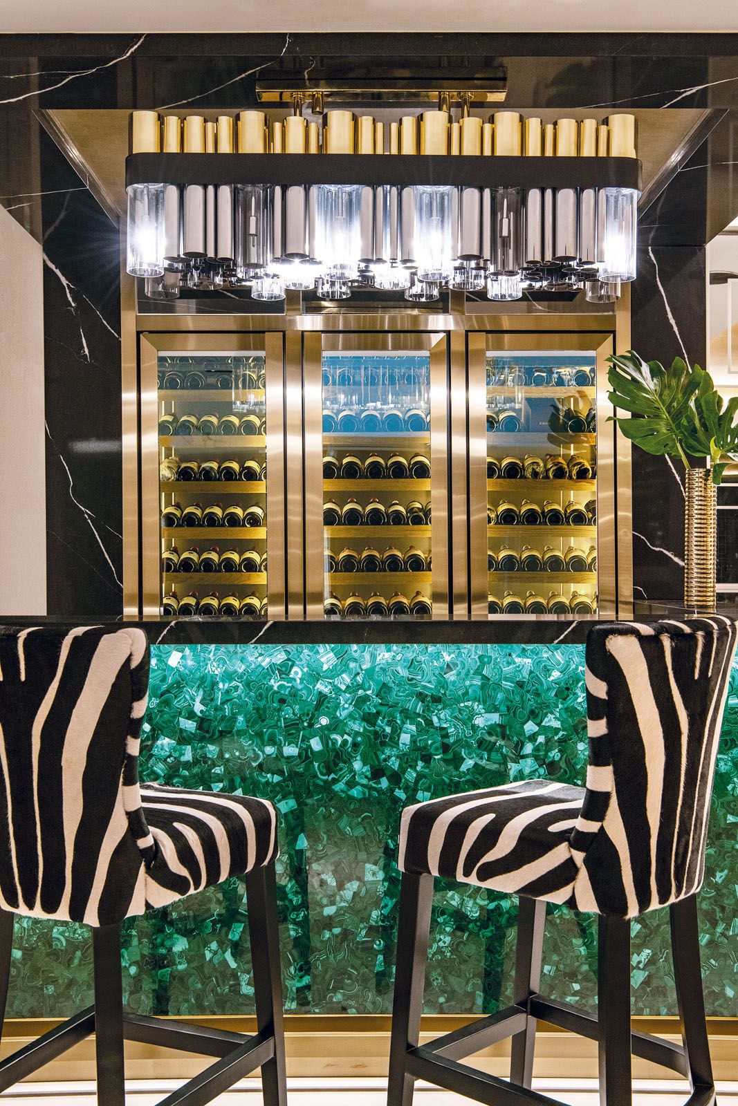 The bar area features zebra-print bar stools, an emerald bar counter and wine chillers that showcase the husband’s collection of winesand spirits