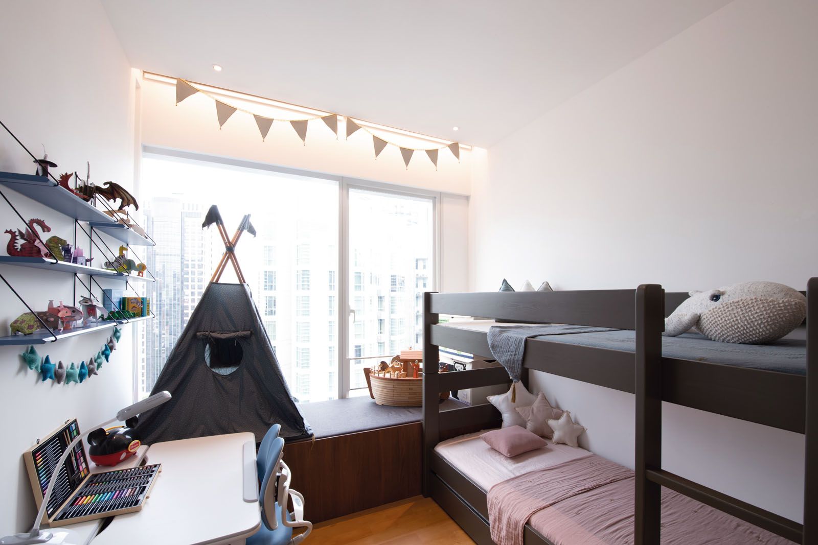 A play tent and a menagerie of animal-shaped origami and toys are among the decorative pieces in the children’s bedroom