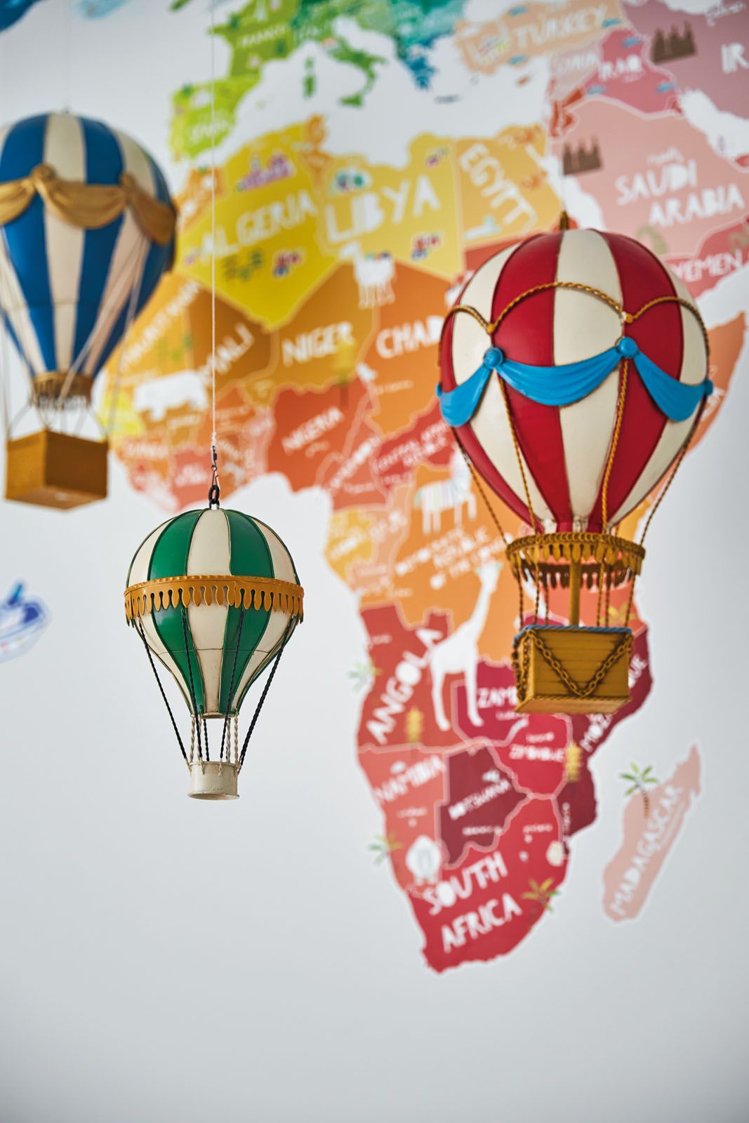 A mobile comprising hot-air balloons celebrates the travel theme