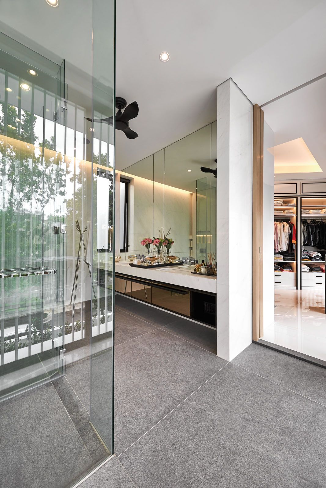 The master bathroom incorporates full-length glass doors while the walk-in wardrobe was inspired by the look of luxury fashion boutiques