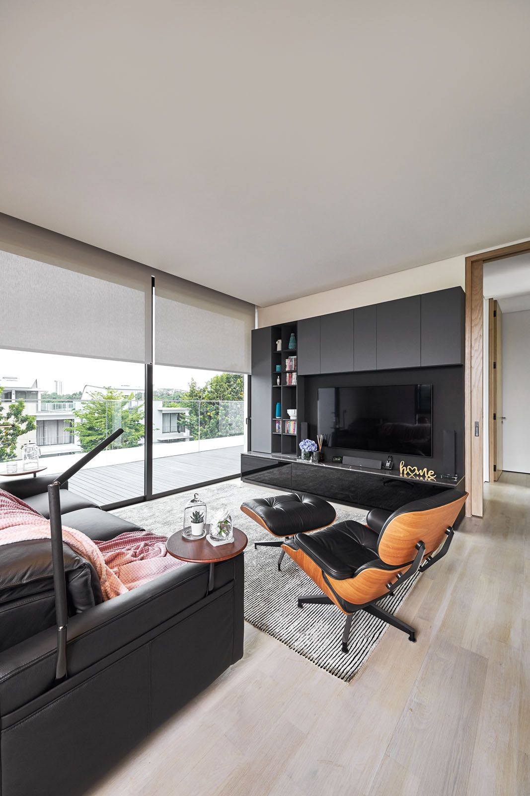 The family room is furnished with the Eames lounge chair and ottoman from Herman Miller and a King Living sofa