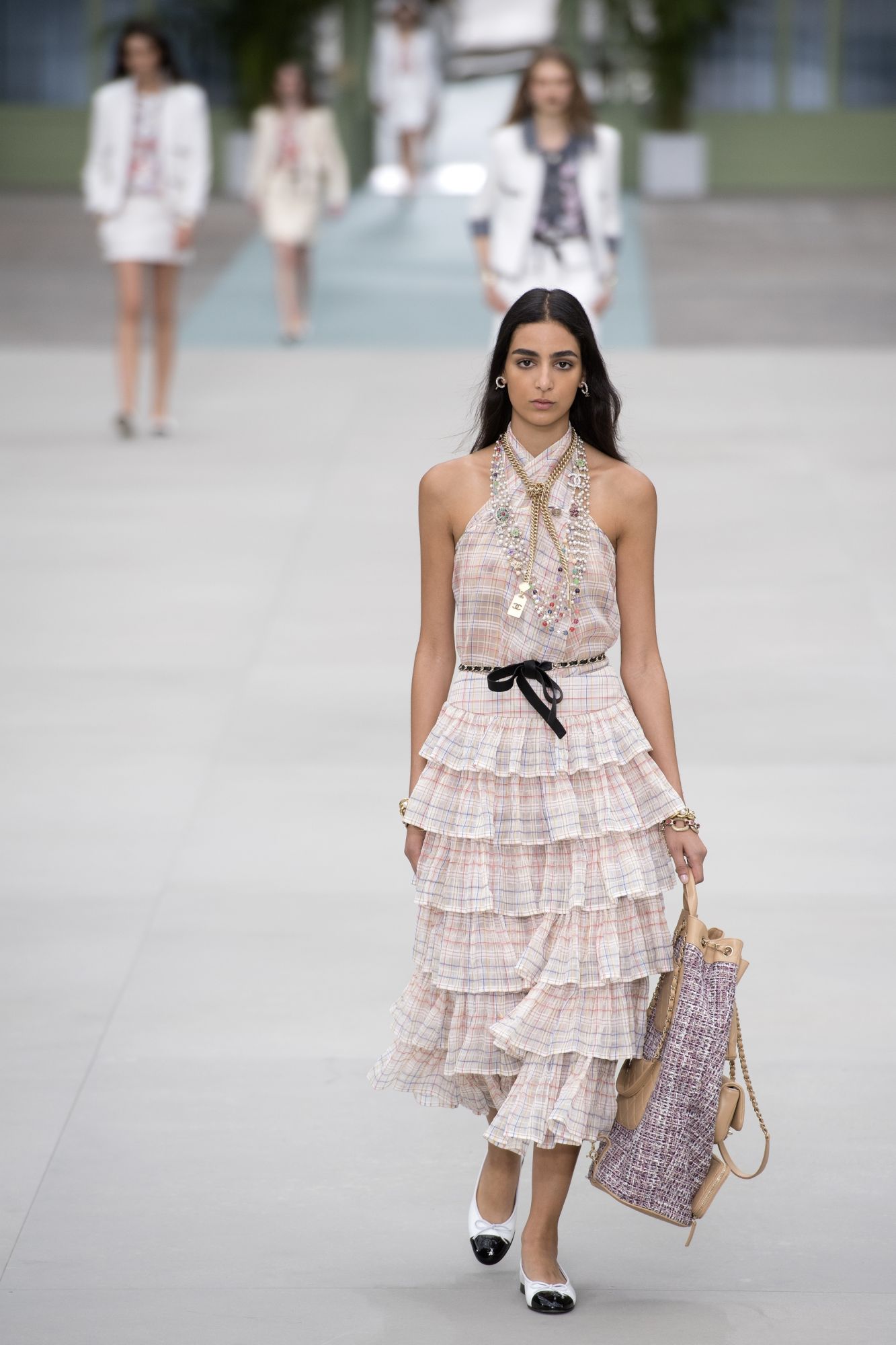 A model presents a creation during the 2020 Chanel Croisiere (Cruise) fashion show at the Grand Palais in Paris on May 3, 2019. (Photo by Christophe ARCHAMBAULT / AFP)