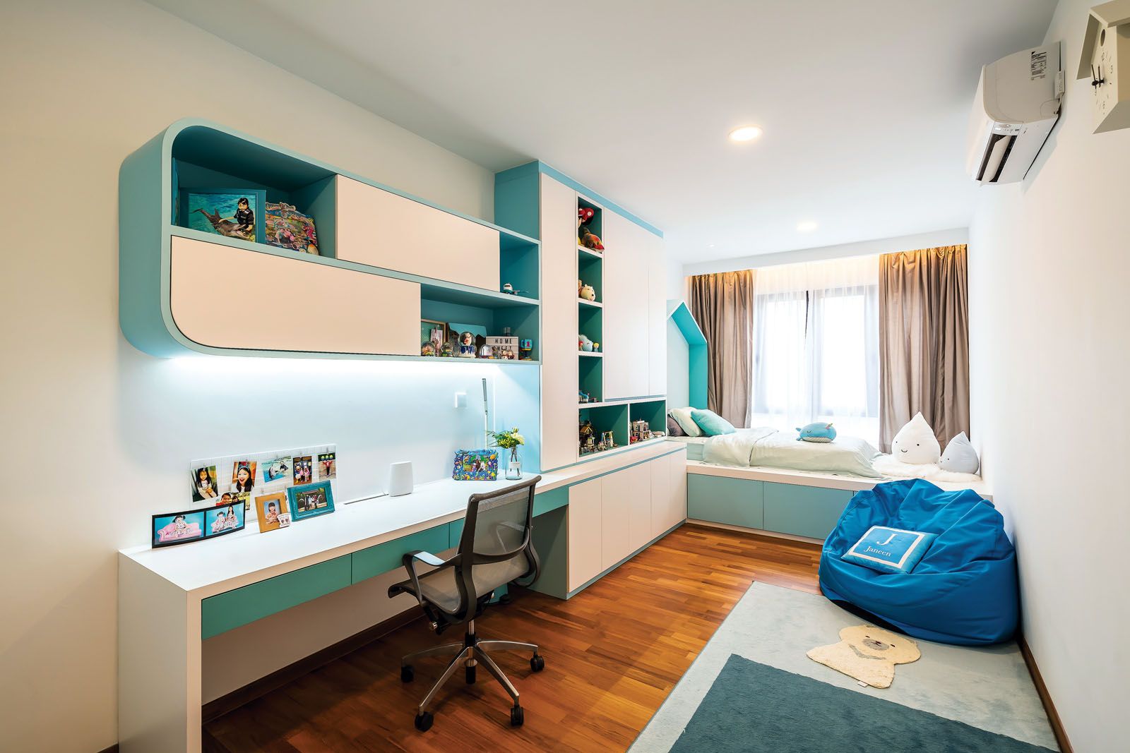 Turquoise elements on the custom-made cabinetry and bed create a fun and playful environment for the couple’s young children