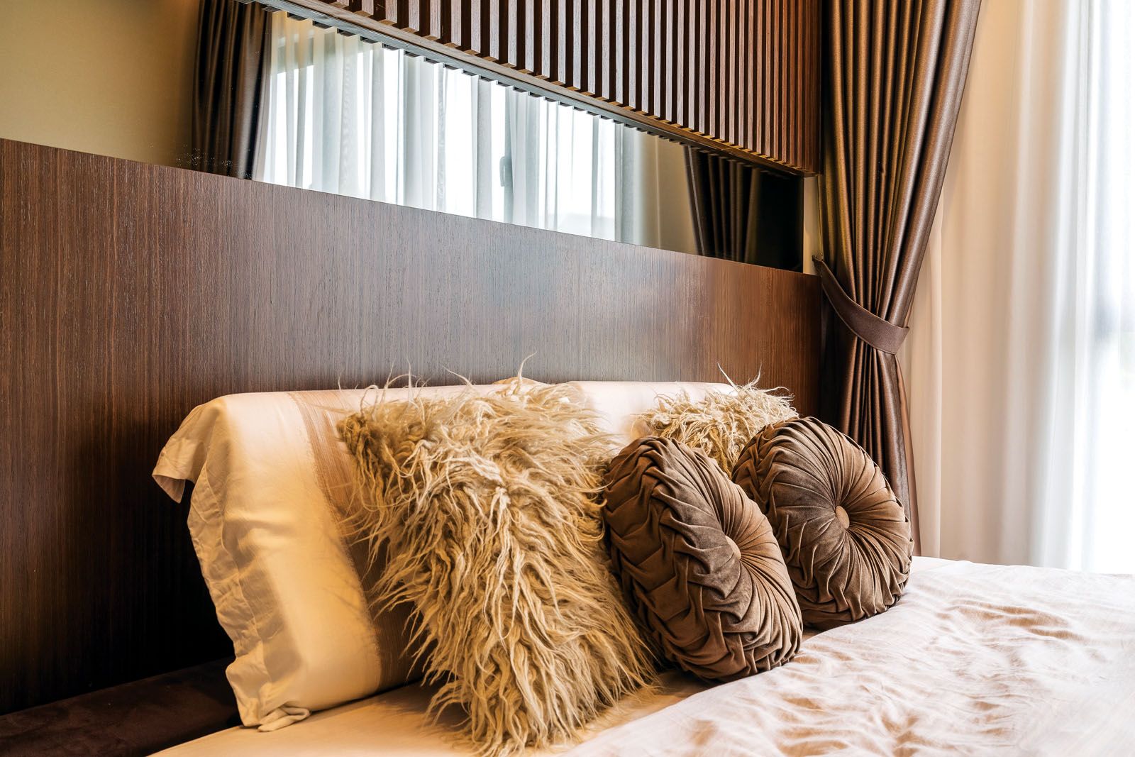 The master bedroom features an earthy palette that contributes to its restful ambience