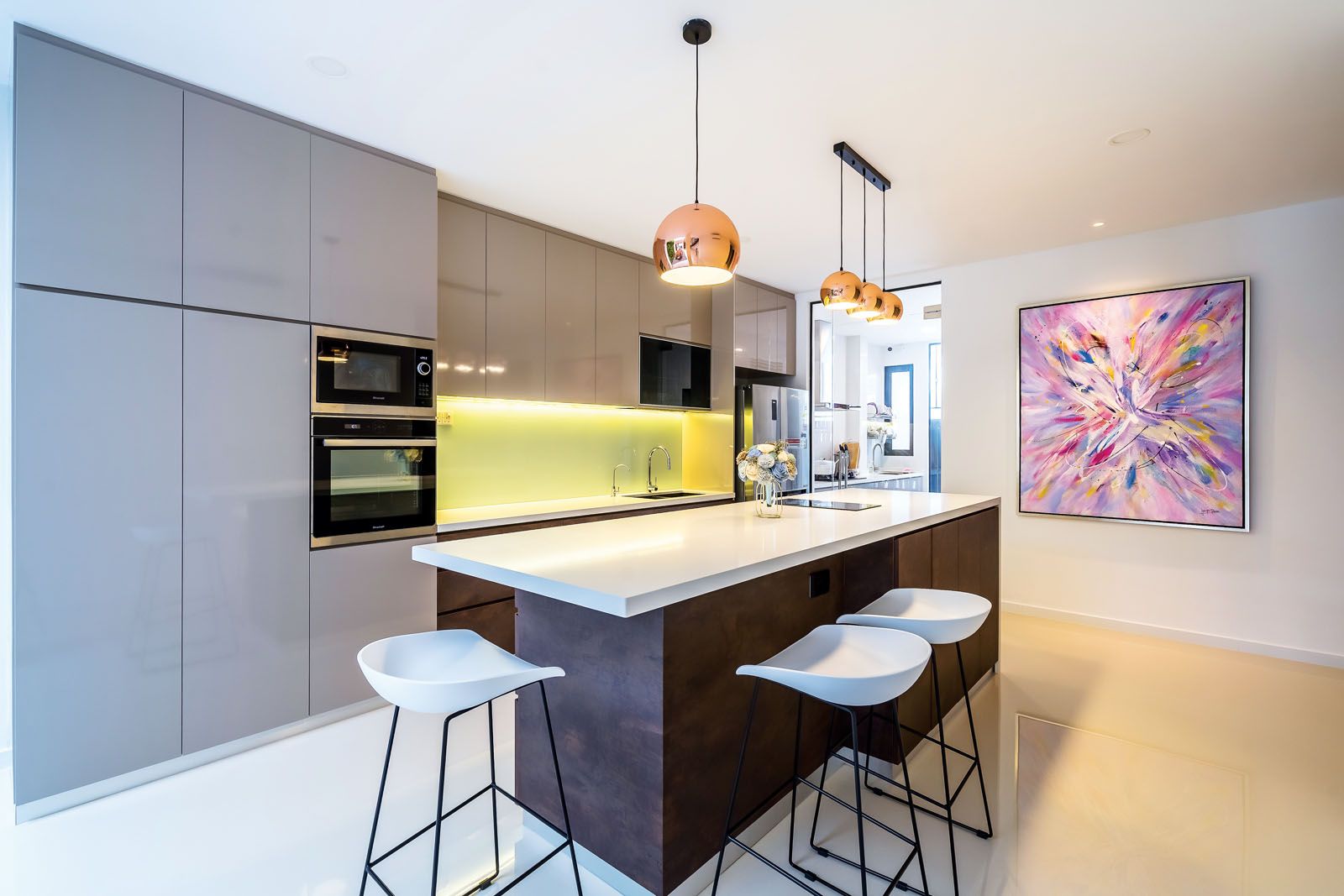 An abstract artwork is the focal point of the kitchen