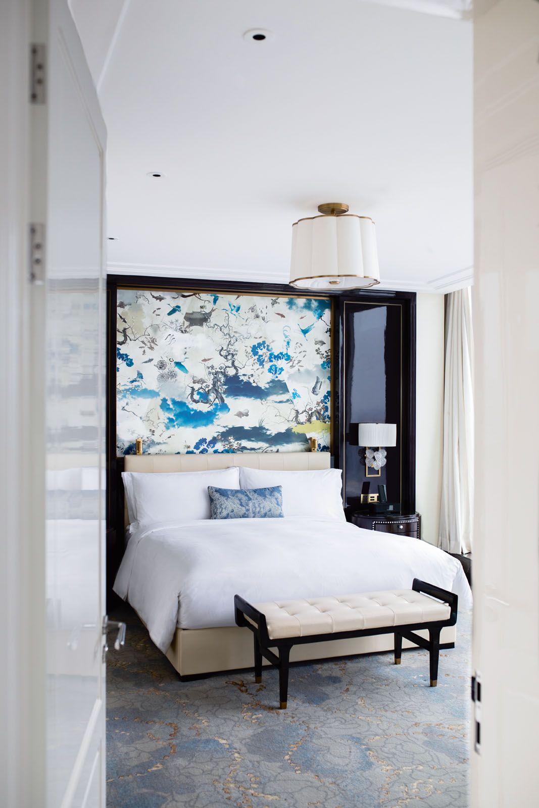 A wall mural in shades of blue livens up a room in the Waldorf Astoria Chengdu hotel, designed by Champalimaud