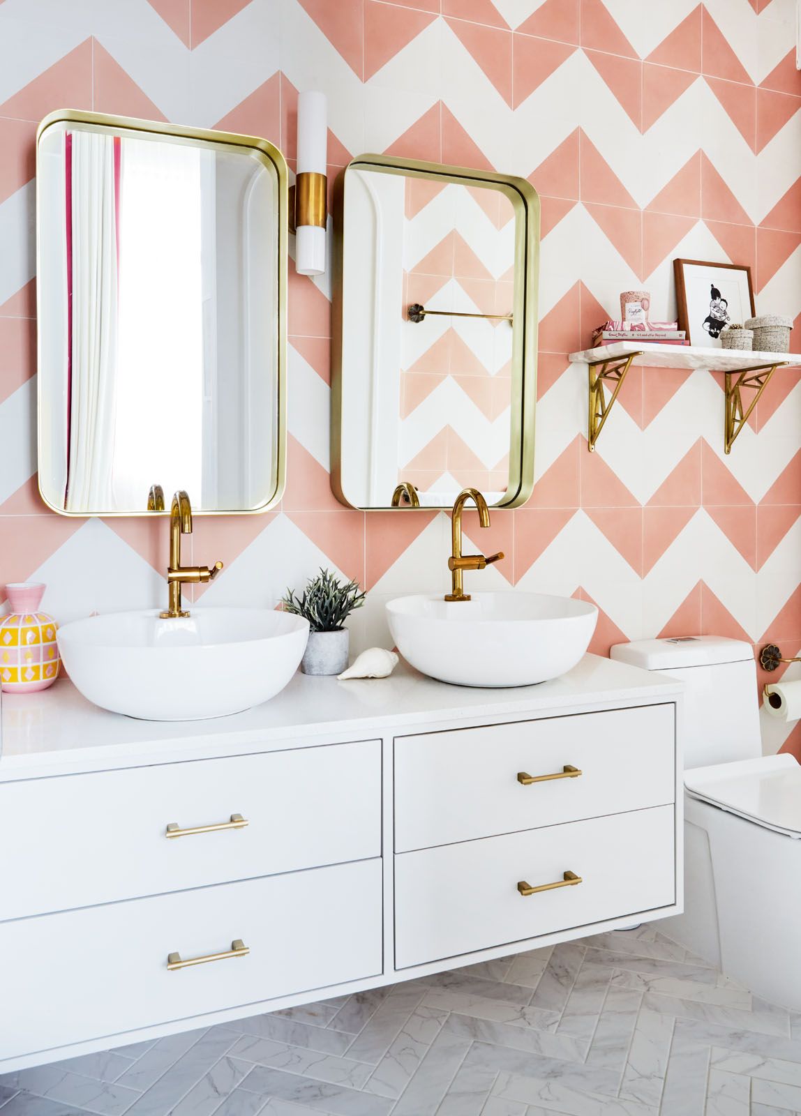 E&A Interiors applied the tiles of the wall and floor of this bathroom in a herringbone pattern