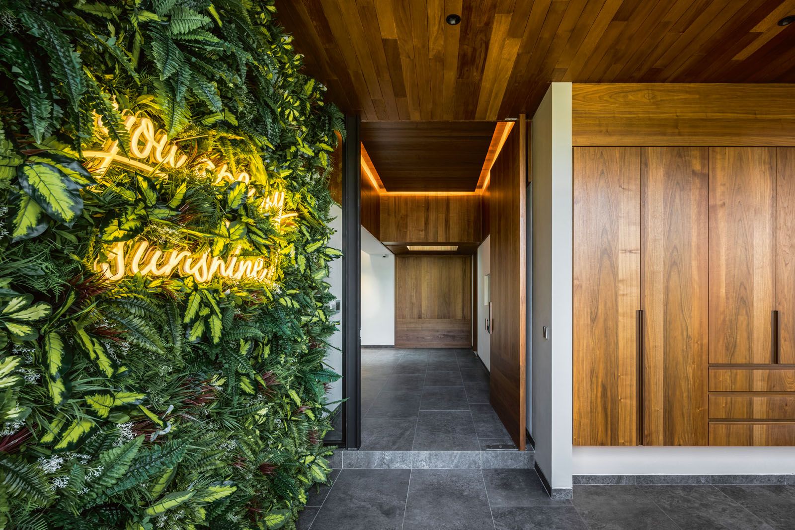 Guests are greeted by the refreshing sight of the vertical garden and cheerful neon signage sited at the entrance