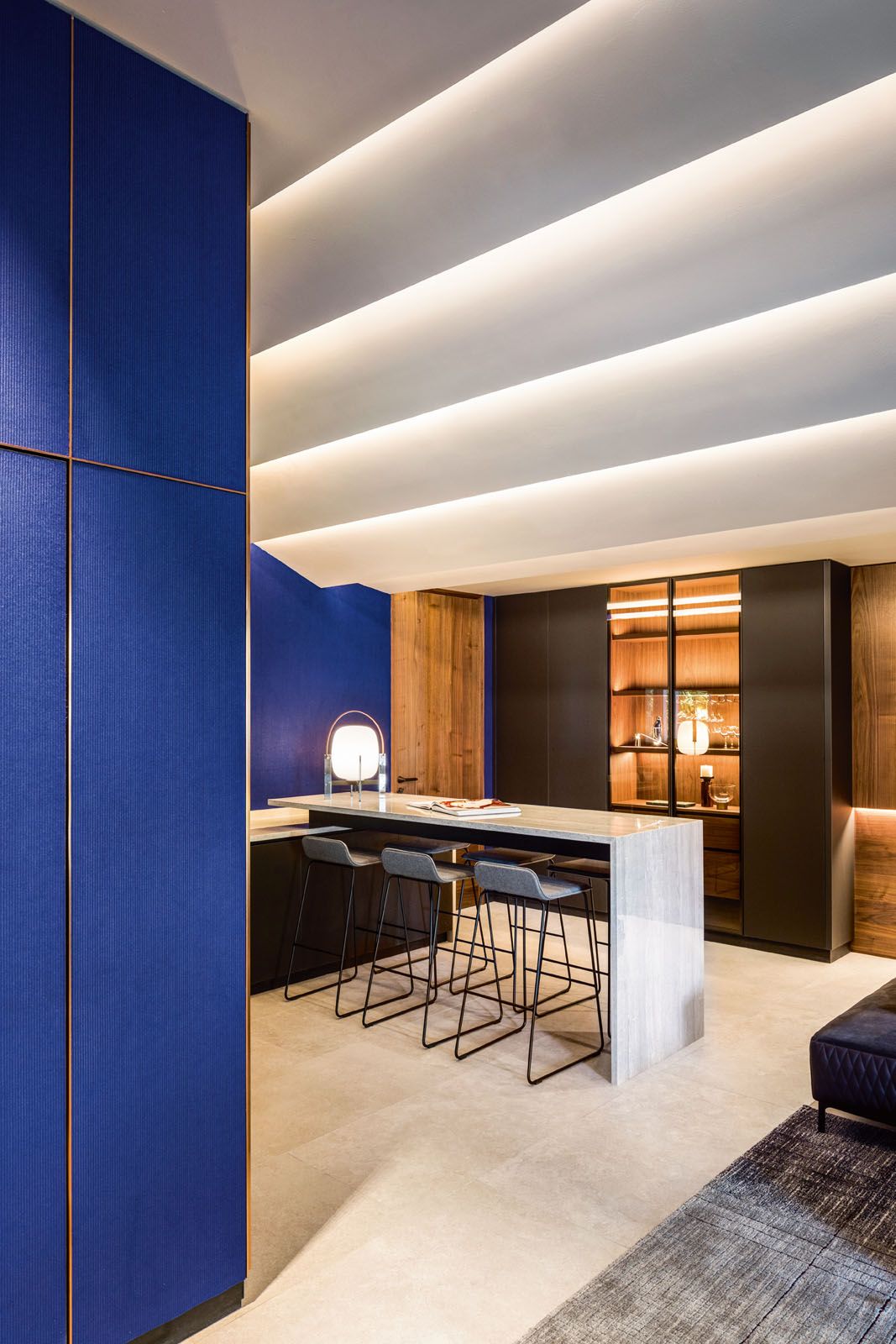 The stepped ceiling of the basement floor creates visual interest while concealing the partial ceiling drop