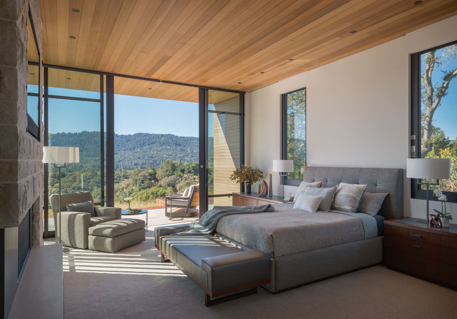 The neutral palette and material mix contribute to the master bedroom’s understated look