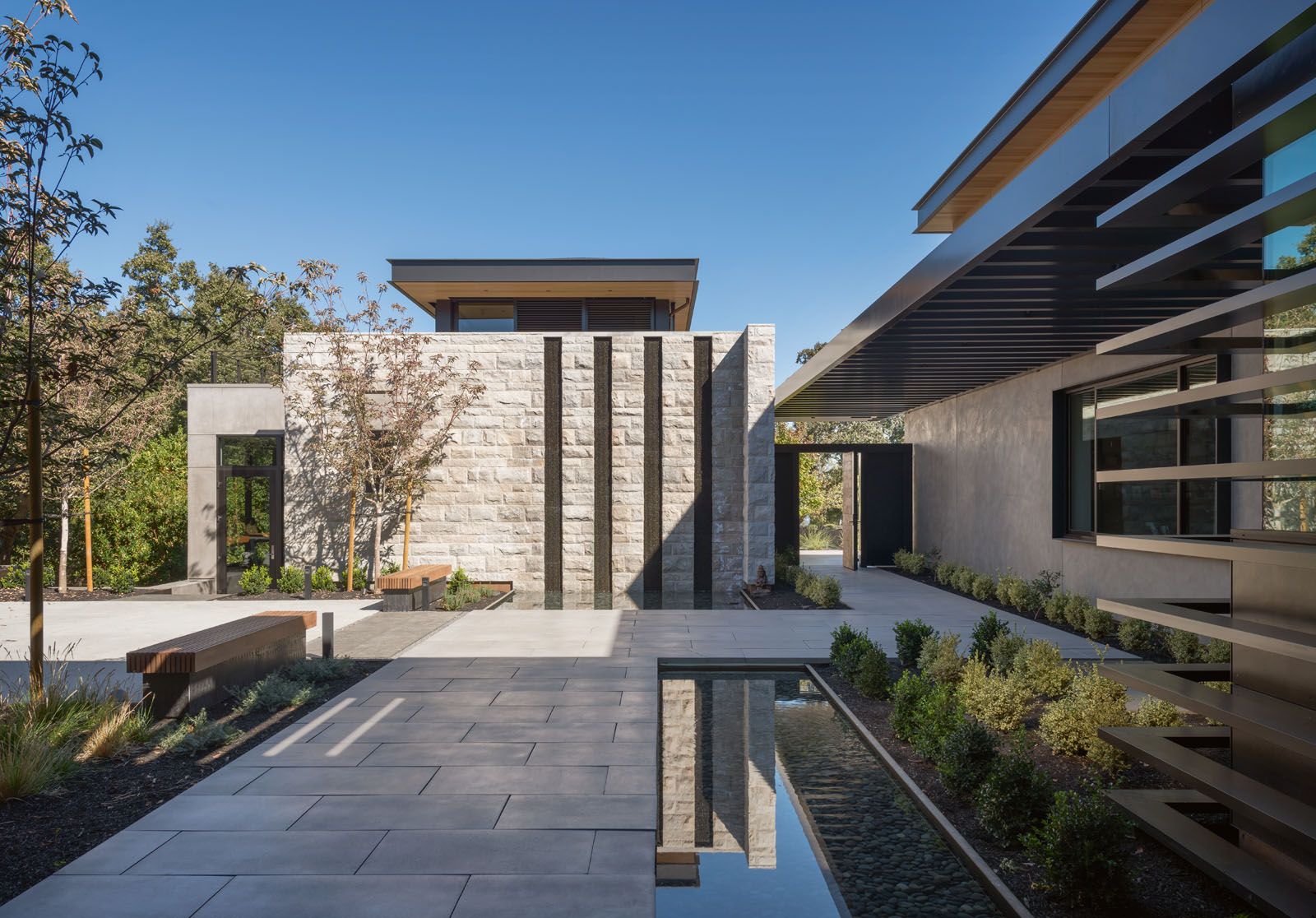 Water features and landscaping in the main courtyard facilitate the tranquil transition into the home