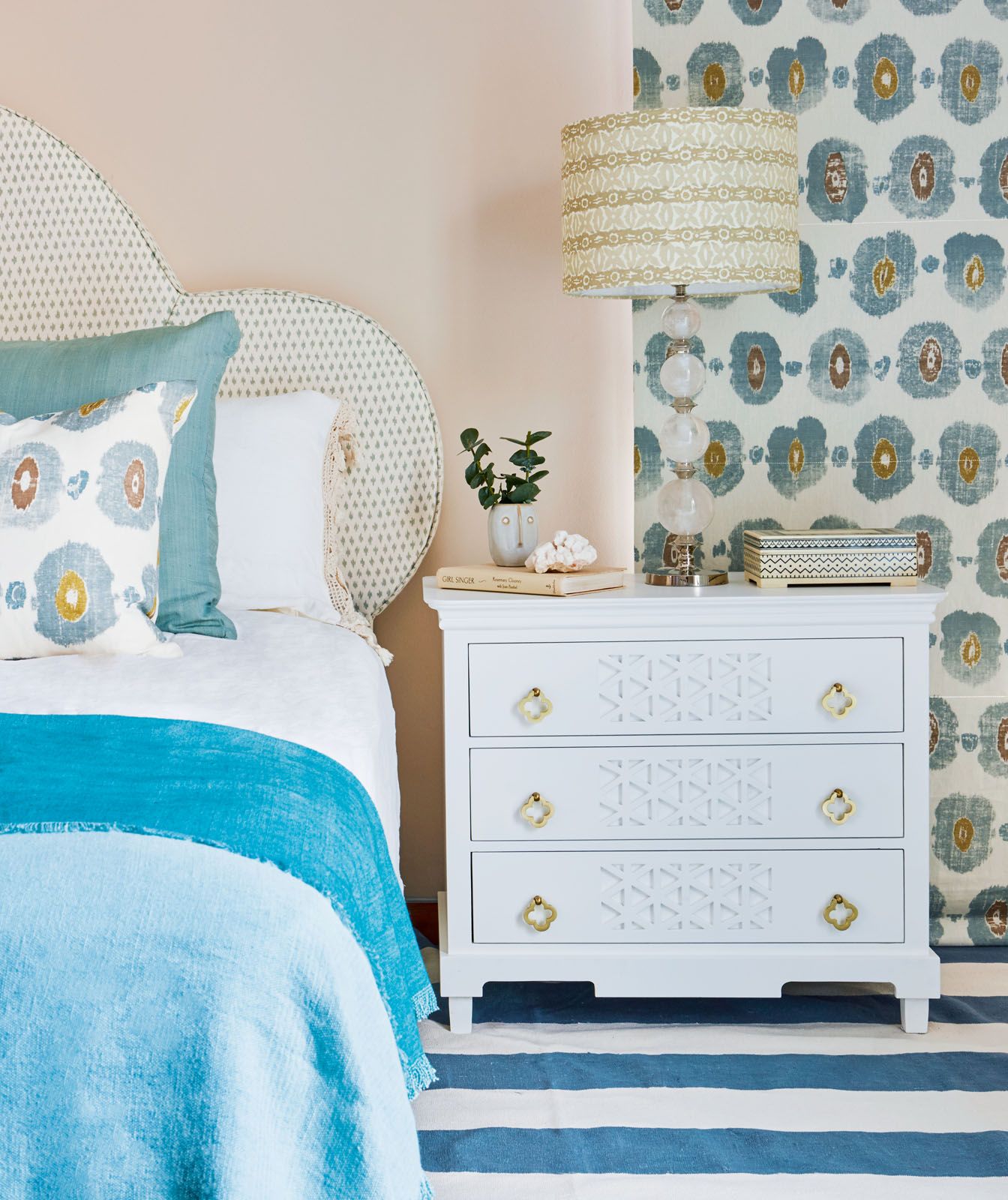 The mix of coral and teal accents elevate the fresh look of this bedroom