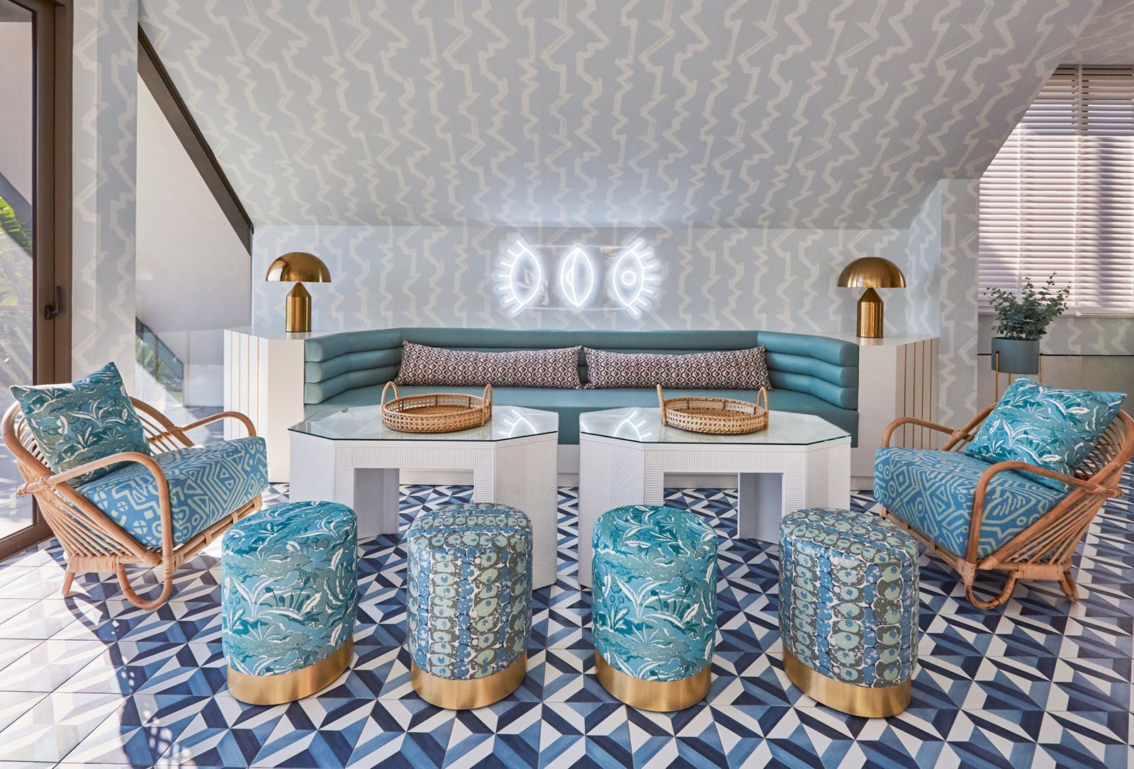 The mix of patterns applied to the furnishings, ceiling and flooring make for a stunning bar and lounge area
