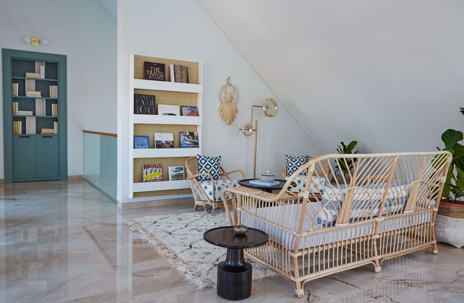 Rattan armchairs and sofas play up the tropical vibe of the home