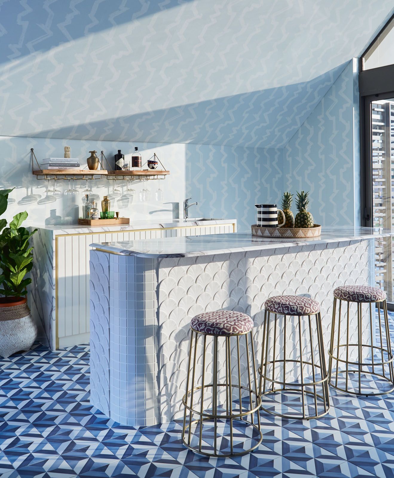 The shell-shaped tiles on the island counter draw cues to the home’s seaside influence