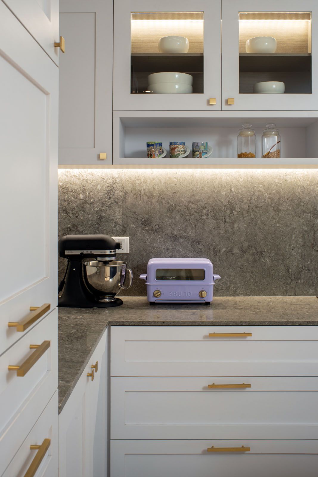 The purple toaster adds a pop of colour to the minimalist kitchen;