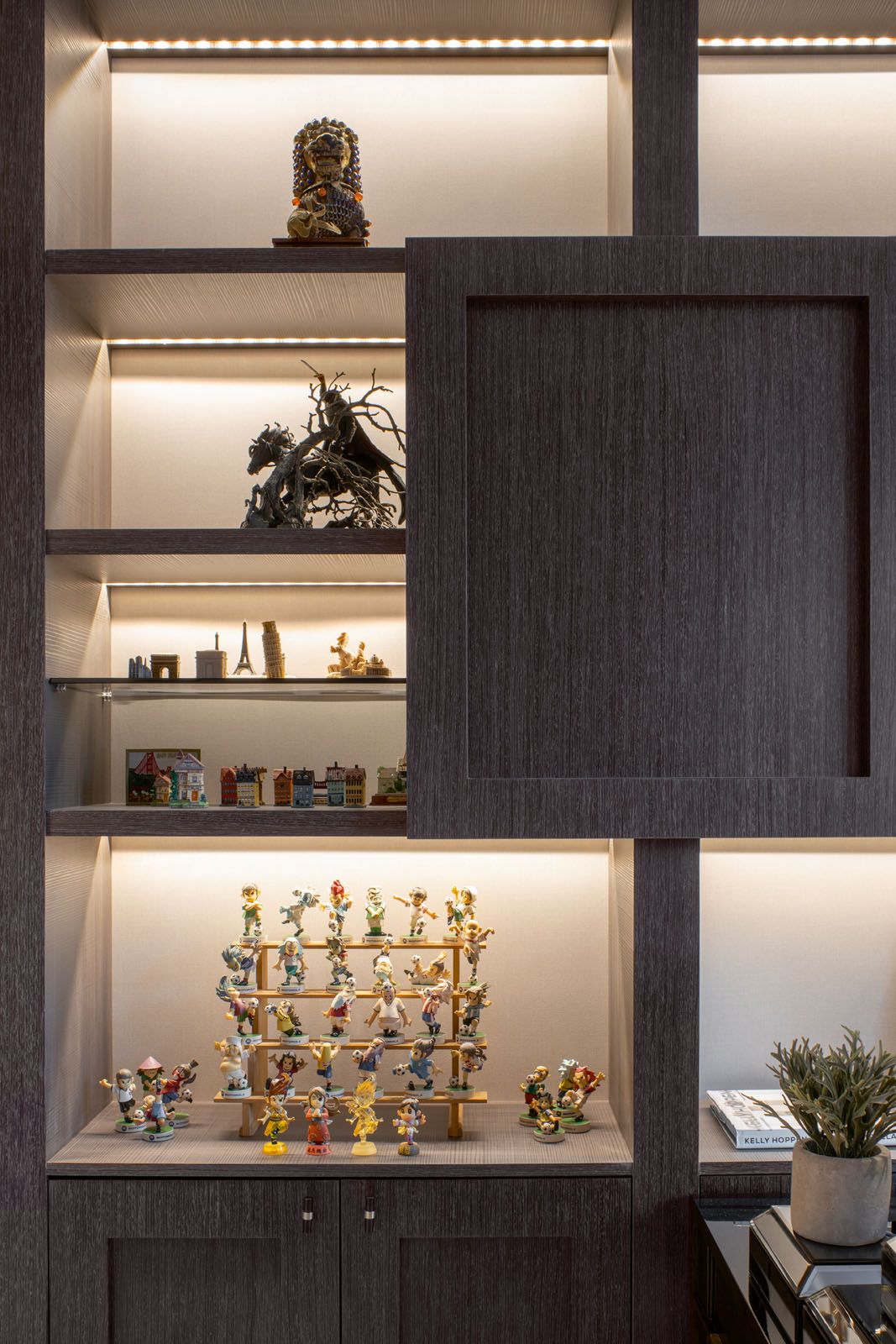 The handsome dark wood cabinetry showcases the couple’s favourite objects and curios