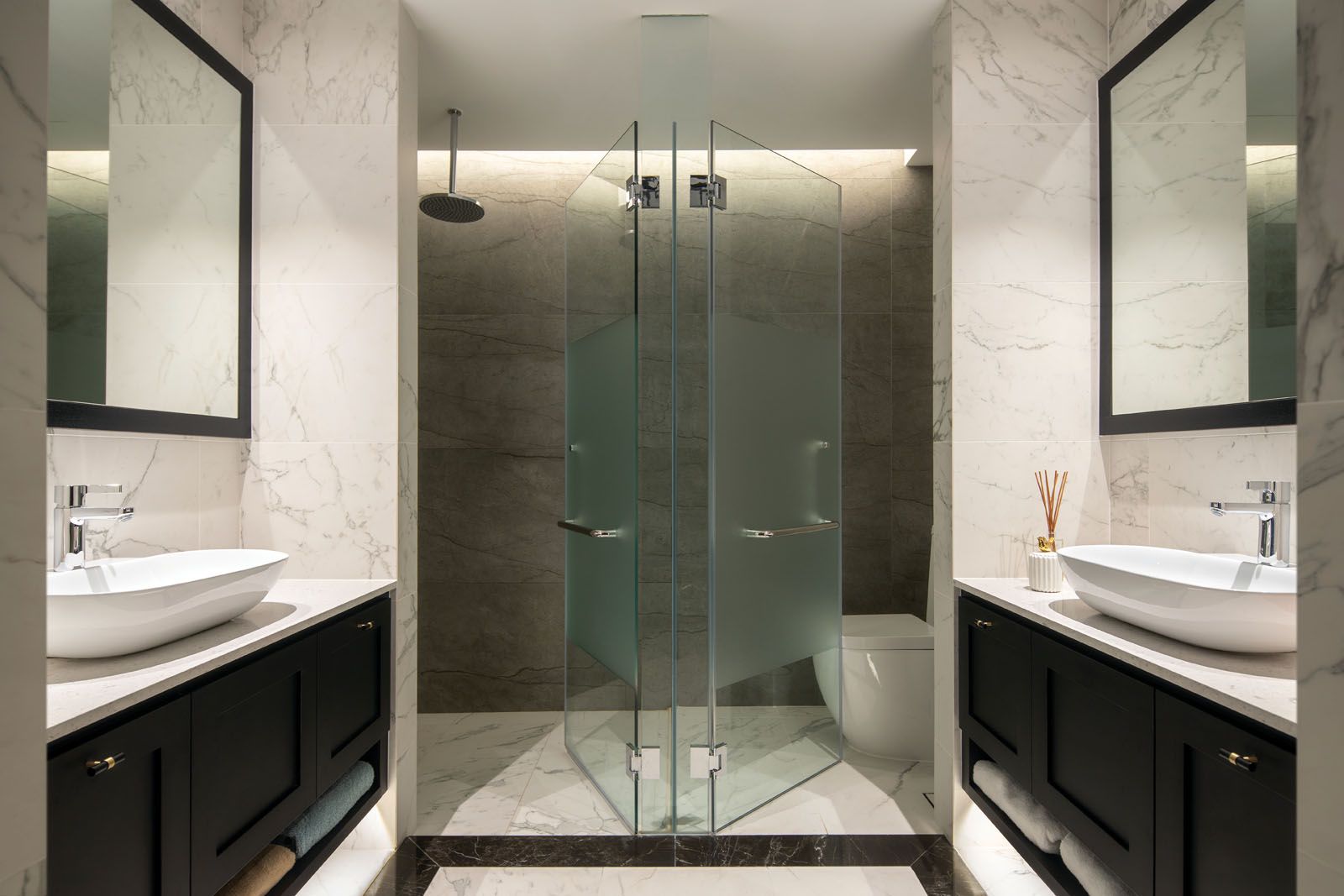 The master bathroom features symmetrical vanity areas for him and her