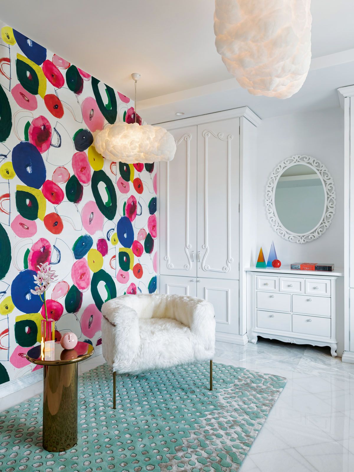 The colour-shaped lamps and the colourful Pierre Frey wallpaper bring a sense of whimsy to this bedroom