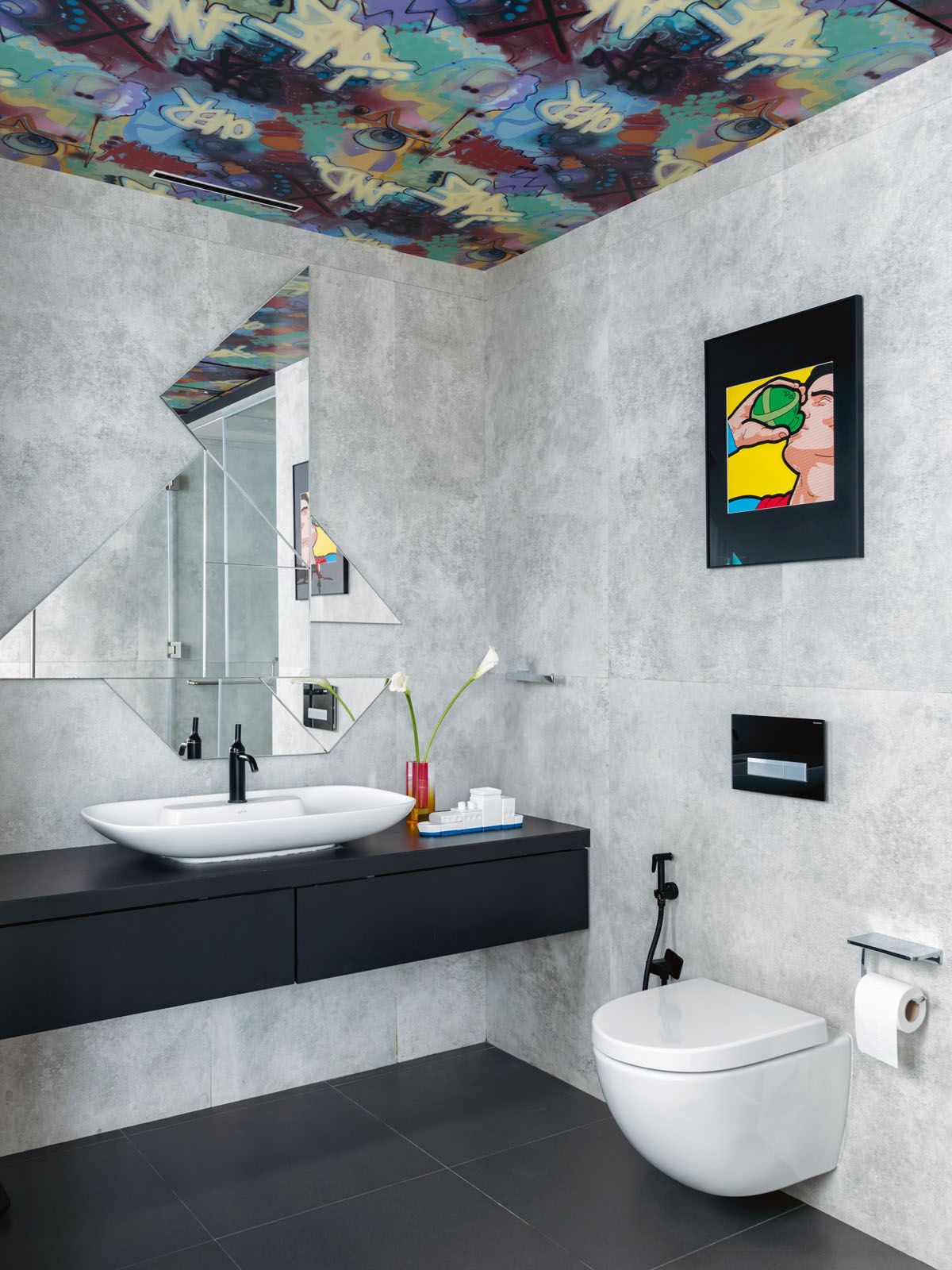 The graffiti design on the ceiling creates an element of surprise in this bathroom