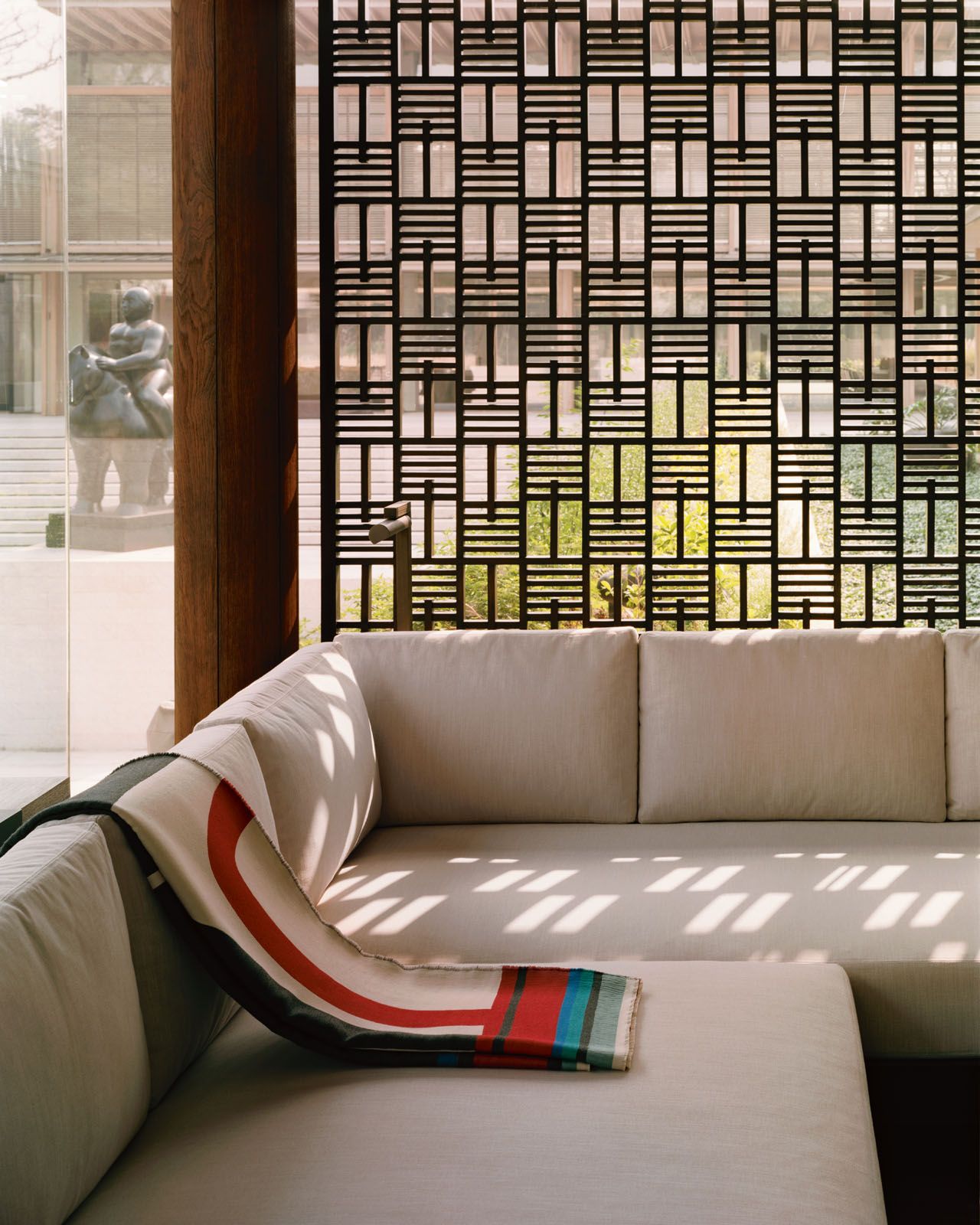 The patterned wooden screens create beautiful shadow play at midday