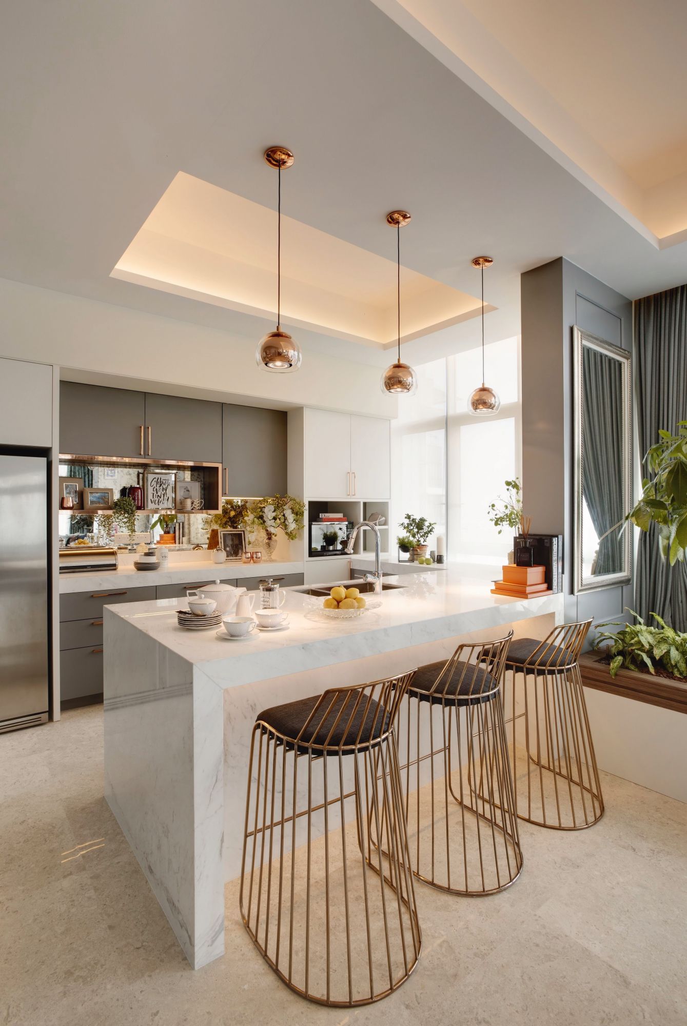 This freestanding kitchen island doubles as a breakfast nook in a project by Prestige Global Designs, resulting in a diligent use of space and a stylish setting