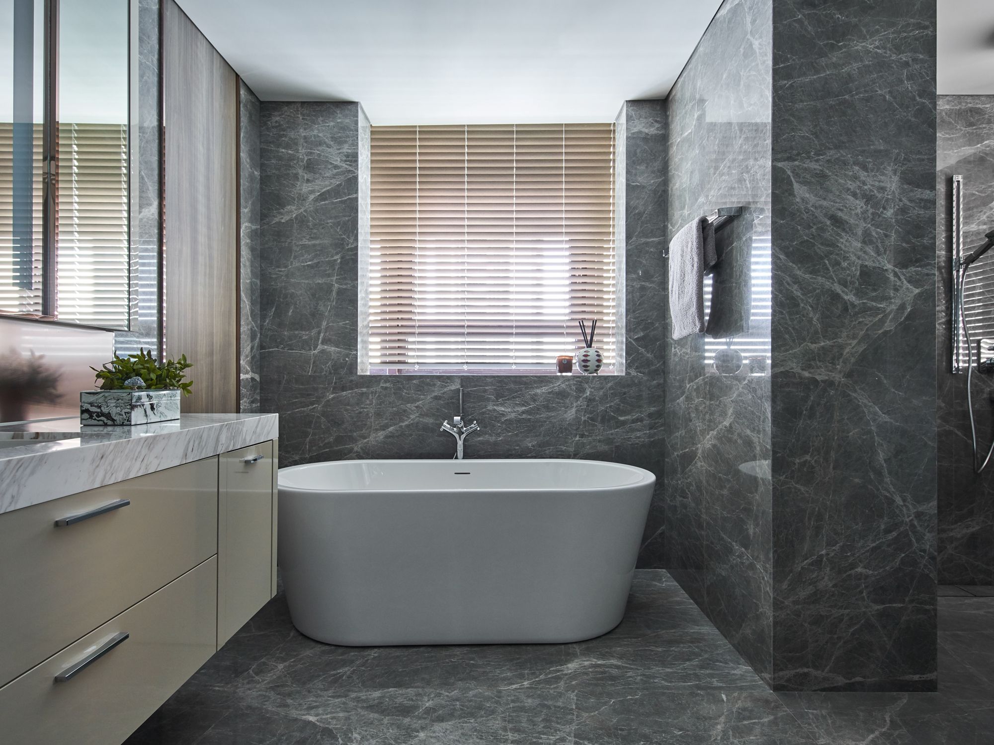 The master bathroom is a tranquil space opulently clad in marble