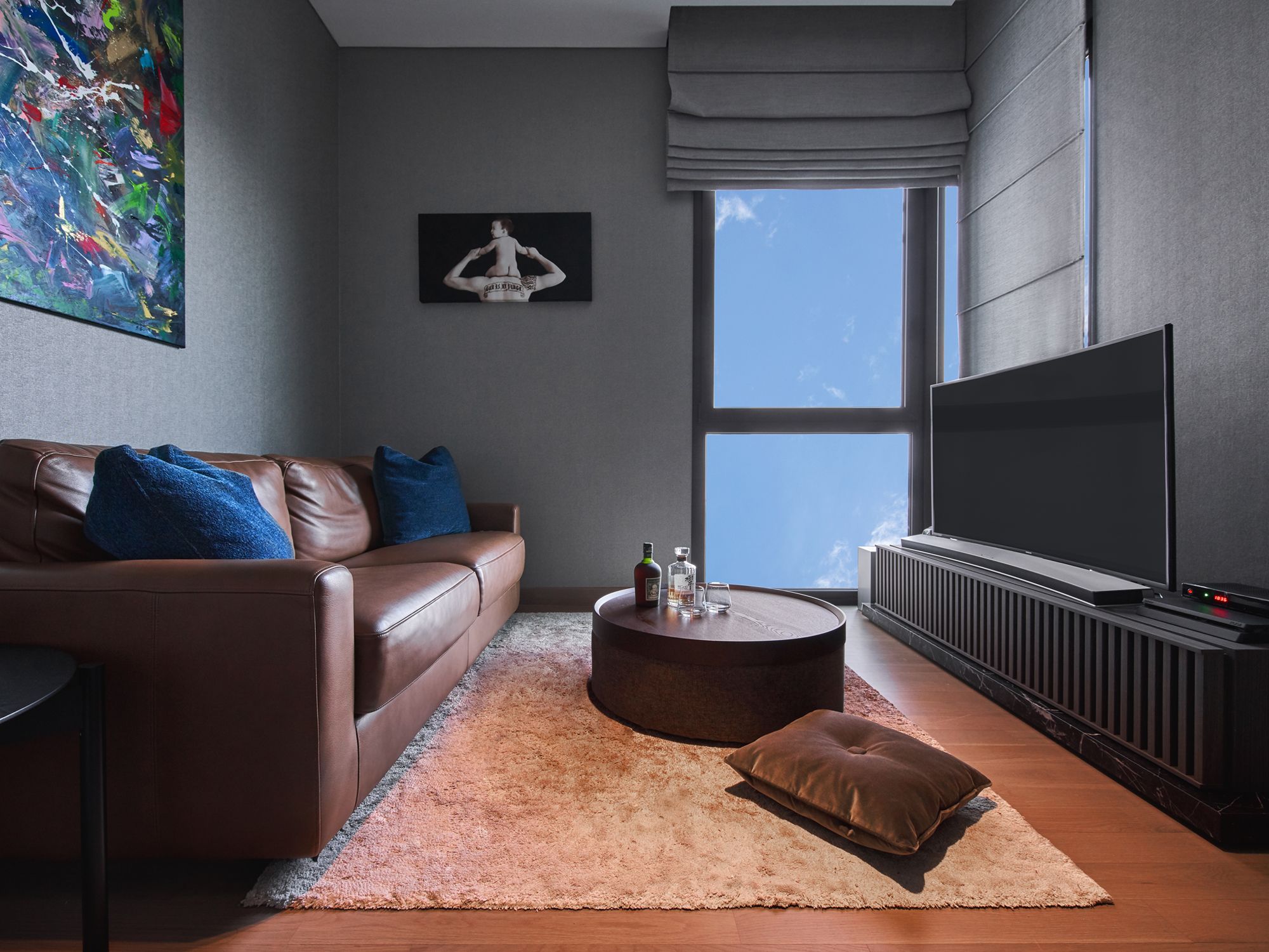 A mix of leather and other plush textures contributes to the cosy atmosphere in this lounge area