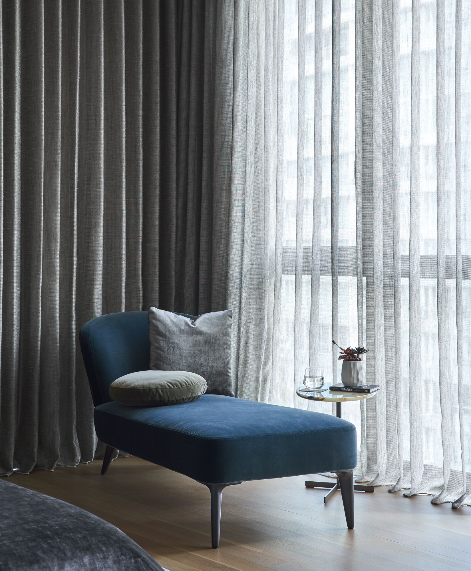 A velvet chaise lounge provides a cosy spot for tea and reading