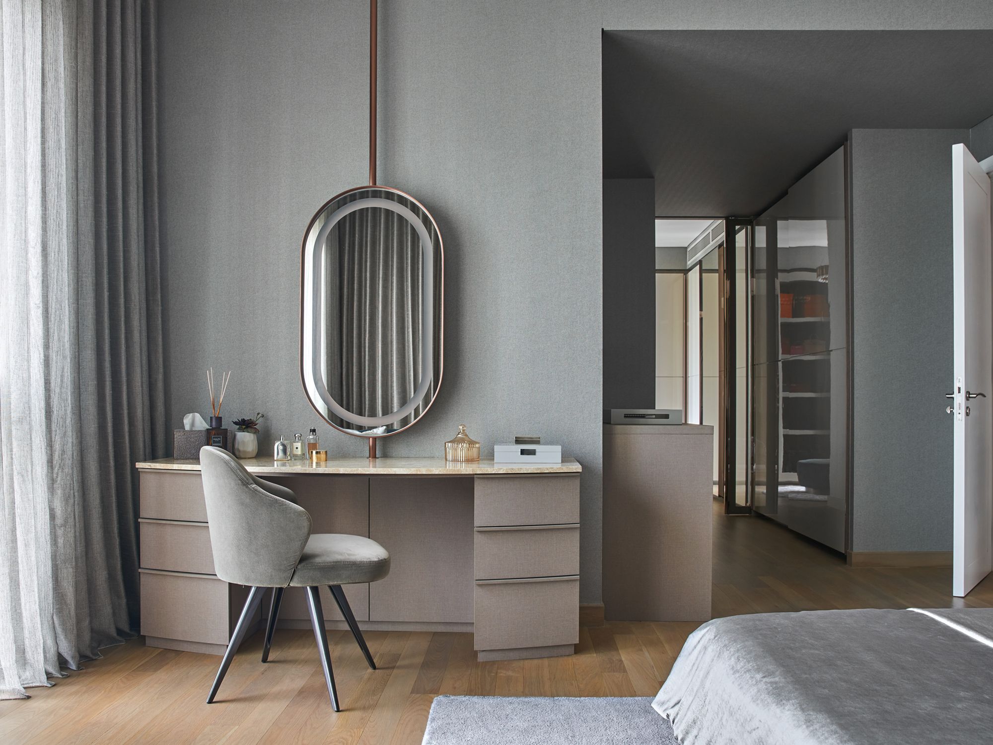 The master bedroom extends the visual language via an identical palette and a mirror similar to that in the dressing area