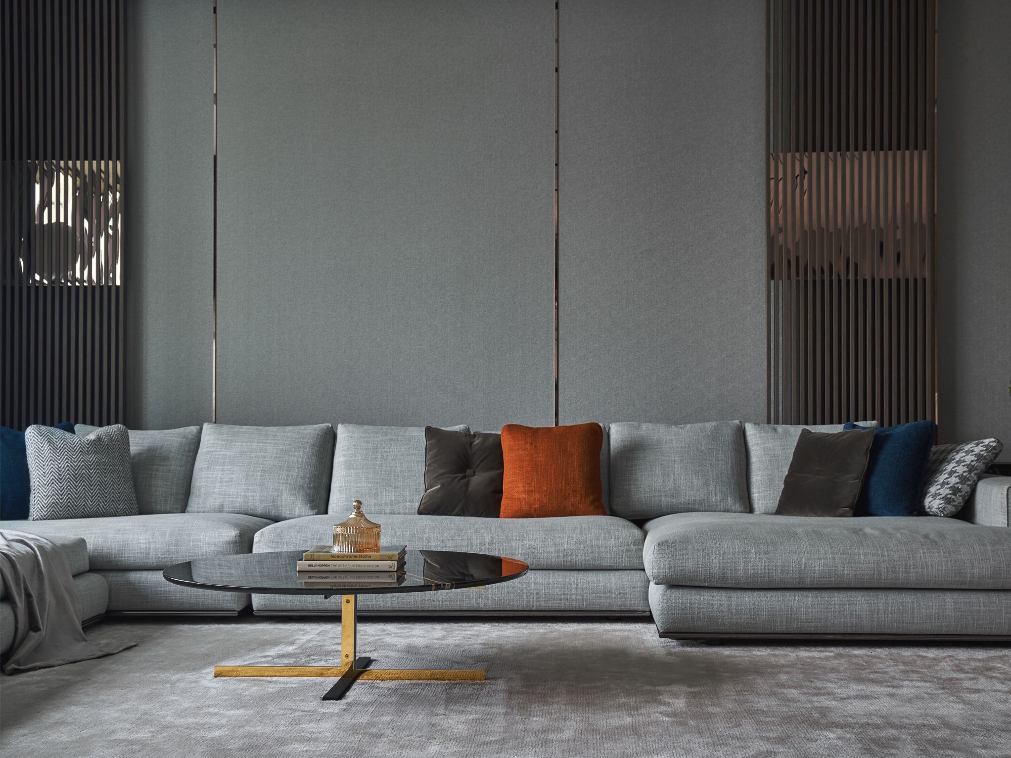 Rose gold trimmings on the panelled wall adds an interesting depth to the living room