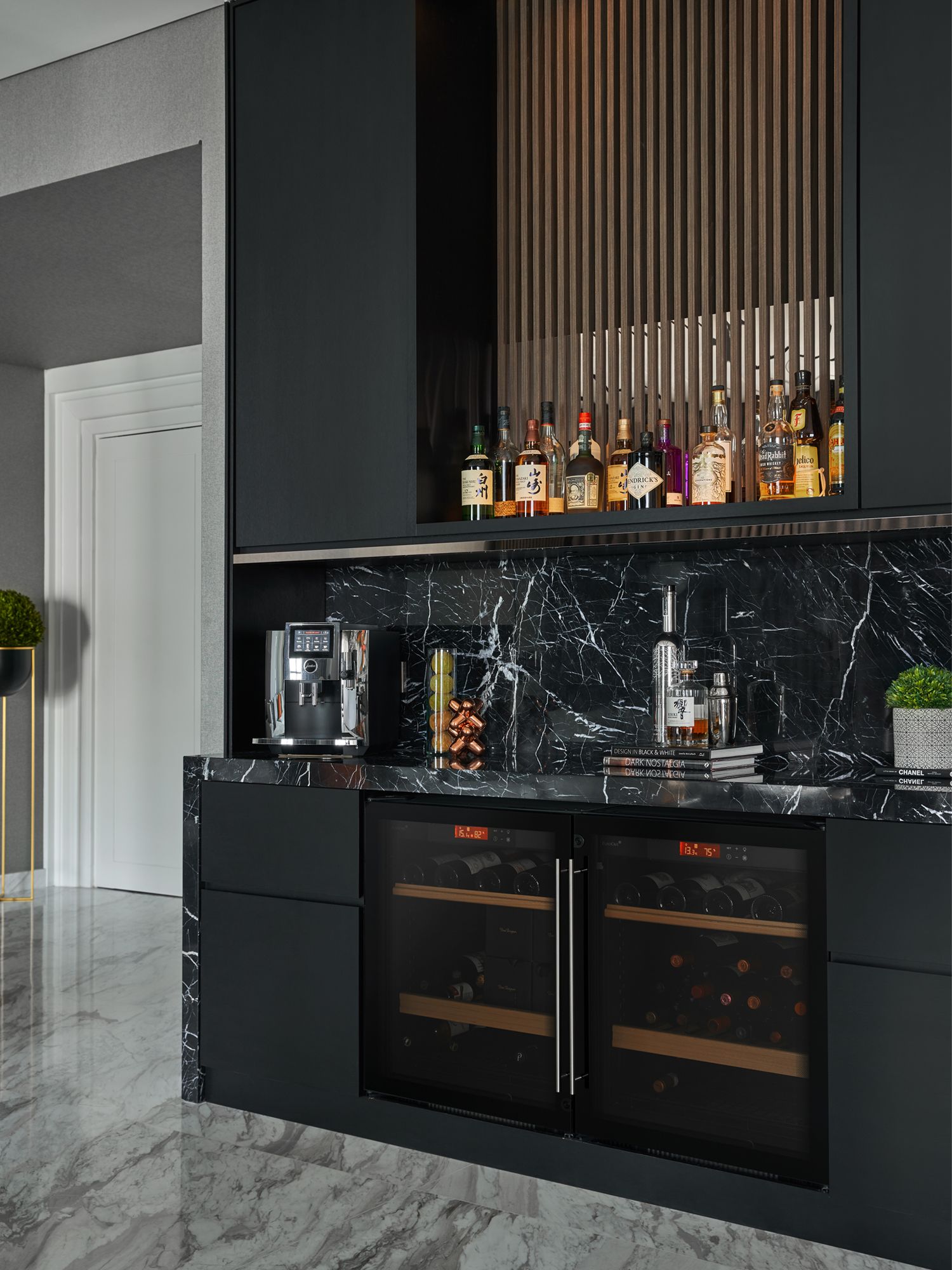 The owner's spirits and whisky collection takes pride of place on the upper shelf of the bar