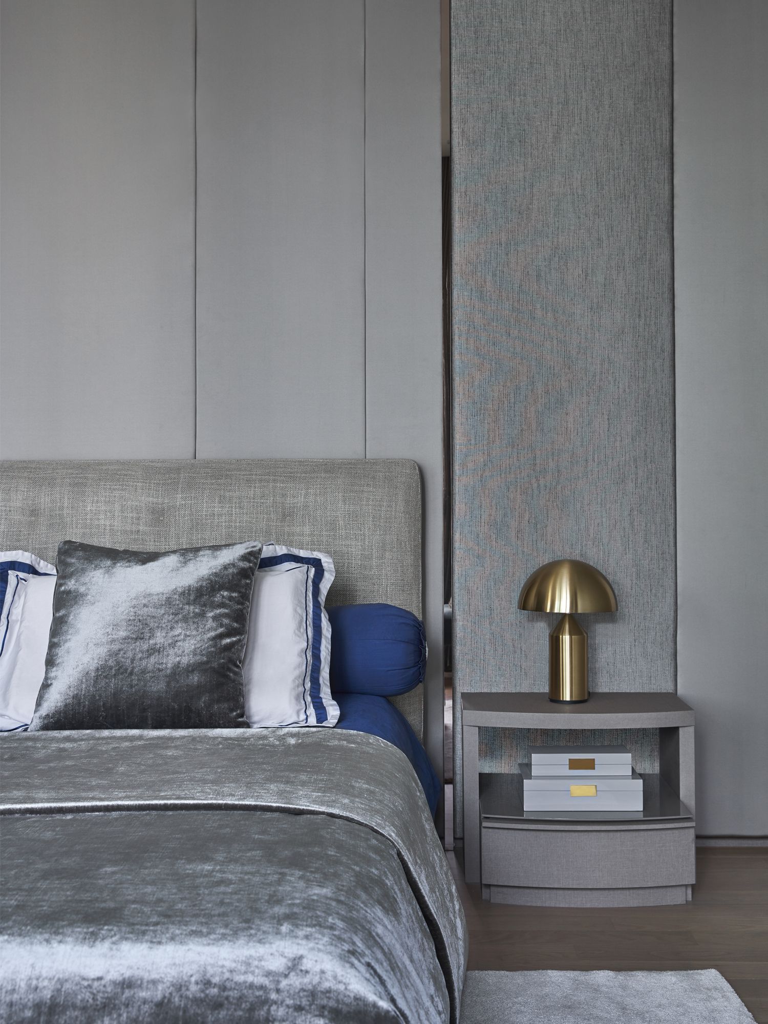 The use of upholstered panels in shades of grey and chrome accents is luxurious yet understated