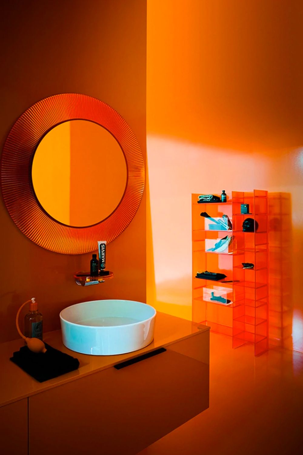 The round Kartell All Saints mirror with its pleated frame creates a striking appearance